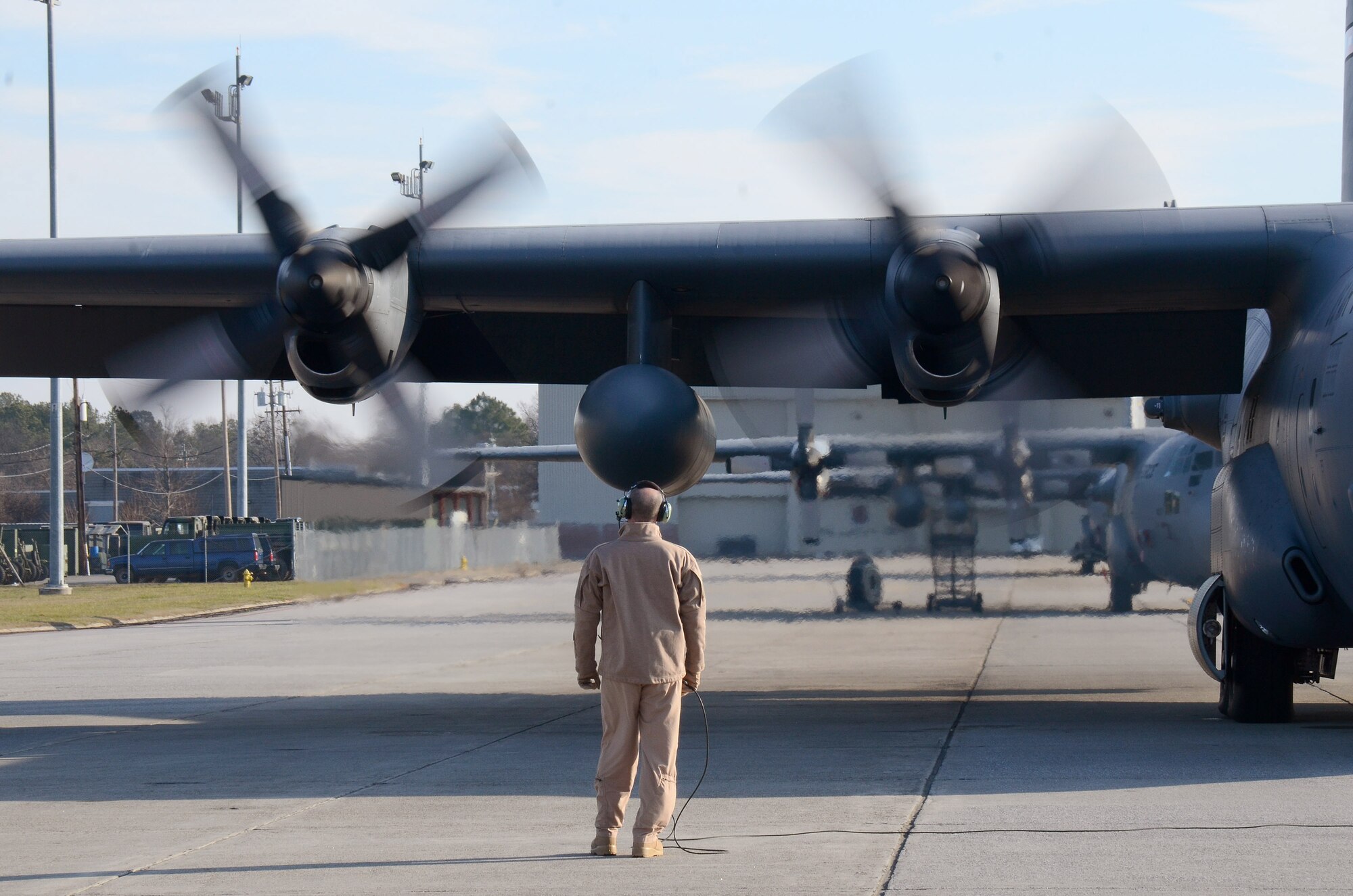 Stan Eval Loadmaster, Senior Master Sgt. Bill Hutchinson, monitors engines start of the 94th Airlift Wing Hercules for deployment to Southwest Asia, Jan. 5, 2015. (U.S. Air Force photo/Brad Fallin)