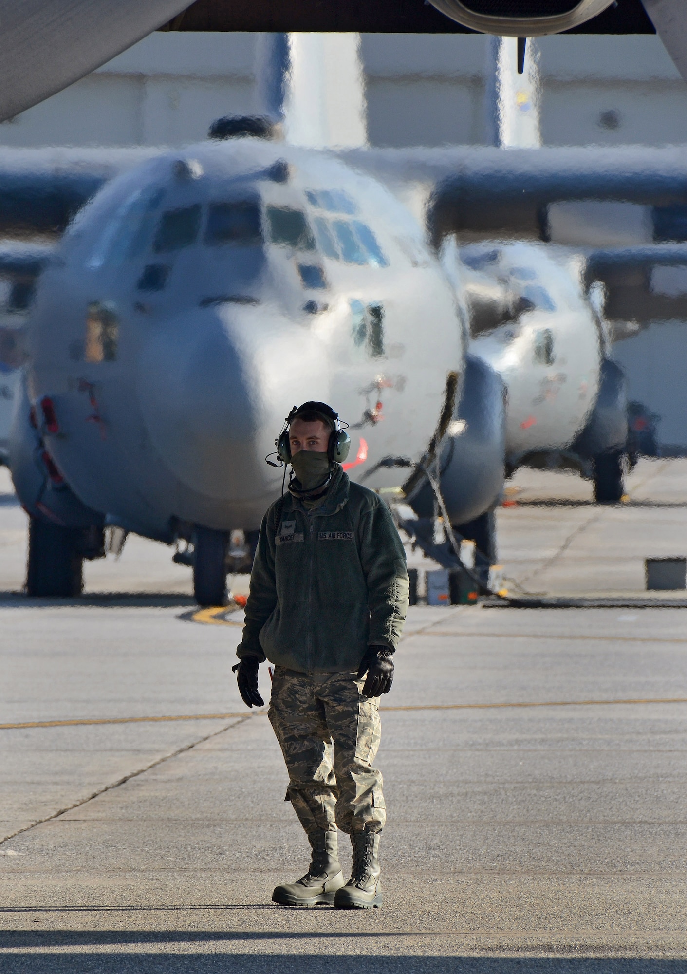 C-130H crew chief Senior Airman David Yancey stands by prior to engines start of the 94th Airlift Wing Hercules as it is being prepared for deployment to Southwest Asia, Jan. 5, 2015. (U.S. Air Force photo/Brad Fallin)