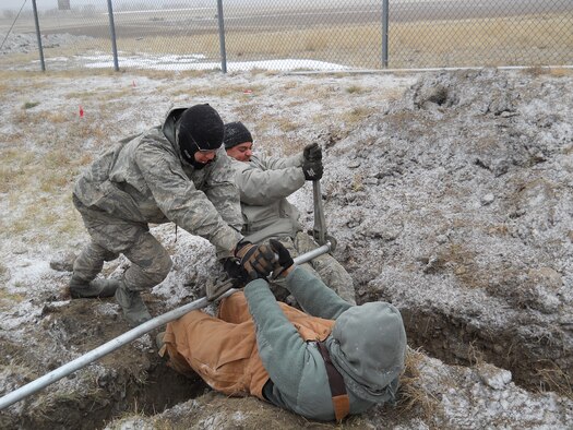 Airmen from the 341st Civil Engineer Squadron work on replacing underground conduit for a Malmstrom Air Force Base missile alert facility garage Oct. 24. Due to the loss of power, alert teams were unable to store their vehicles out of the elements and had limited access to the facility. (U.S. Air Force/courtesy photo)