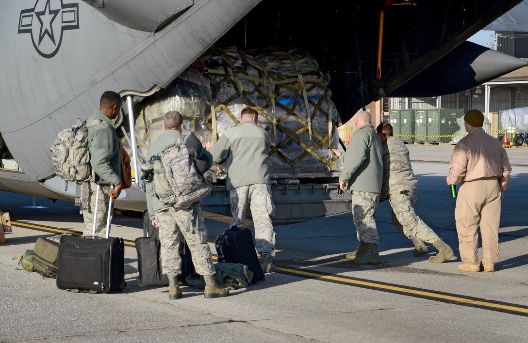 Deploying members of the 94th Airlift Wing make adjustments to the final cargo pallet's location on the loading ramp in preparation for their Southwest Asia deployment, Jan. 5, 2015 at Dobbins Air Reserve Base, Ga.  (U.S. Air Force photo/Brad Fallin)