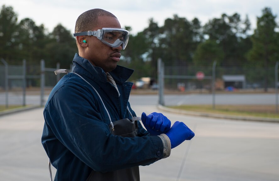 U.S. Air Force Airman 1st Class Donovohn Brown, 23d Logistics Readiness Squadron fuels distribution operator, uses hand signals during a checkpoint inspection Jan. 22, 2015, at Moody Air Force Base, Ga. Brown used signals to direct an Airman operating a Kovatch R-11 aircraft refueler throughout the two-person inspection. (U.S. Air Force photo by Airman 1st Class Ceaira Tinsley)