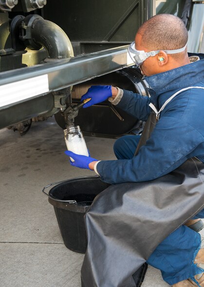 U.S. Air Force Airman 1st Class Donovohn Brown, 23d Logistics Readiness Squadron fuels distribution operator, drains a sump tank during a checkpoint inspection Jan. 22, 2015, at Moody Air Force Base, Ga. Brown drained the tank to check the fuel for water and sediments. (U.S. Air Force photo by Airman 1st Class Ceaira Tinsley)