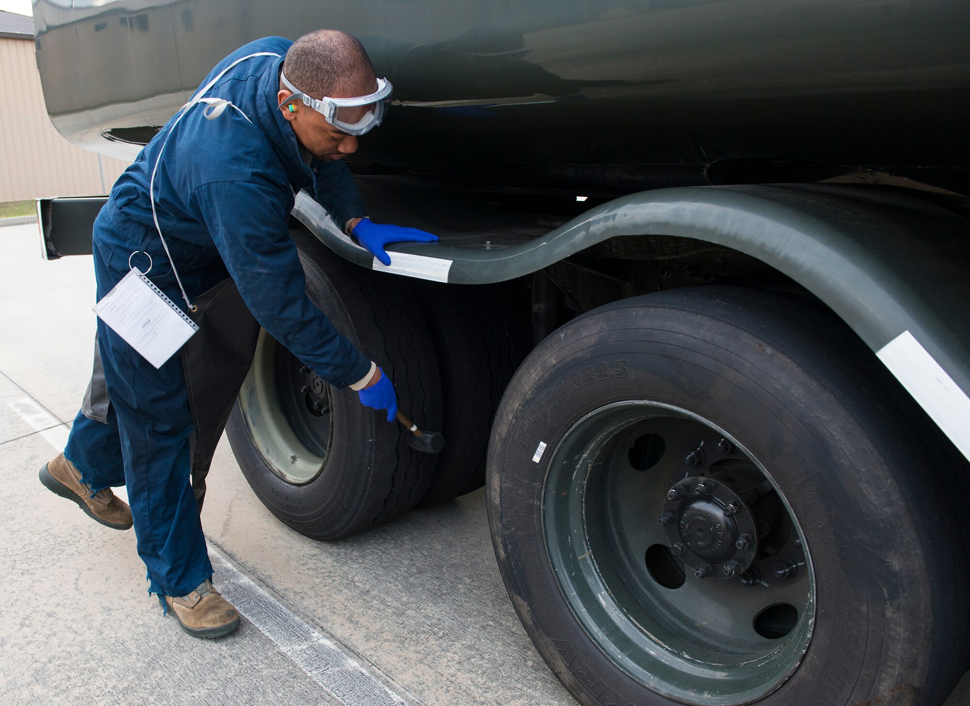 U.S. Air Force Airman 1st Class Donovohn Brown, 23d Logistics Readiness Squadron fuels distribution operator, checks tire pressure during a checkpoint inspection Jan. 22, 2015, at Moody Air Force Base, Ga. The 23d LRS performs the inspection daily to ensure safety and prevent issues on the flightline. (U.S. Air Force photo by Airman 1st Class Ceaira Tinsley)