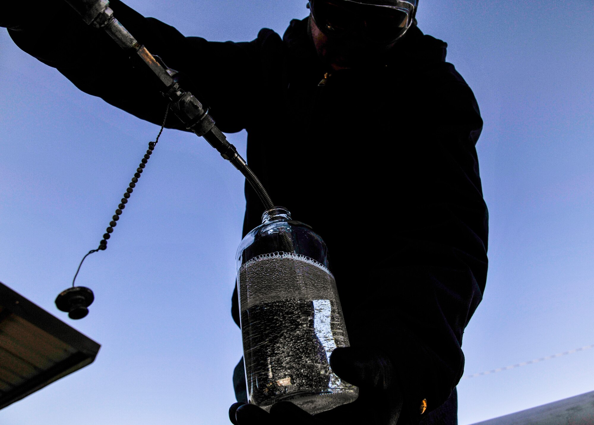 Ernie Gilmore, a 19th Logistics Readiness Squadron bulk fuels terminal technician, inspects a jar filled with jet fuel Jan. 5, 2015, at Little Rock Air Force Base, Ark. Terminal technicians at Little Rock AFB frequently inspect arriving fuel to ensure it is free of any water or debris. (U.S. Air Force photo by Airman 1st Class Harry Brexel)