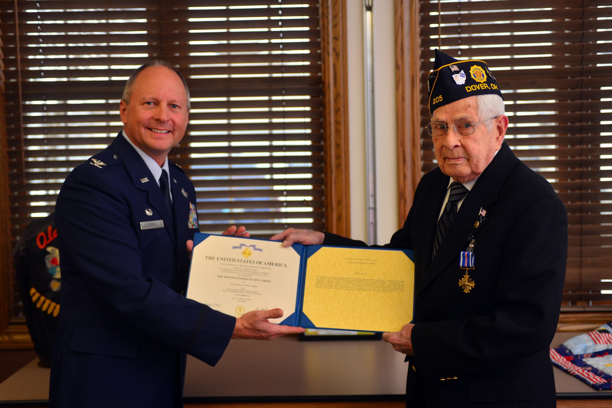 U.S. Air Force Col. Jim Jones, 121st Air Refueling Wing Commander, presents retired Staff Sgt. Jesse Reese with the Distinguished Flying Cross medal Jan. 16, 2015, in Dover, Ohio. Reese earned the medal on Dec. 31, 1944,  as a tail gunner over the skies of Hamburg, Germany. (U.S. Air National Guard photo by Master Sgt. Ralph Branson/Released)
