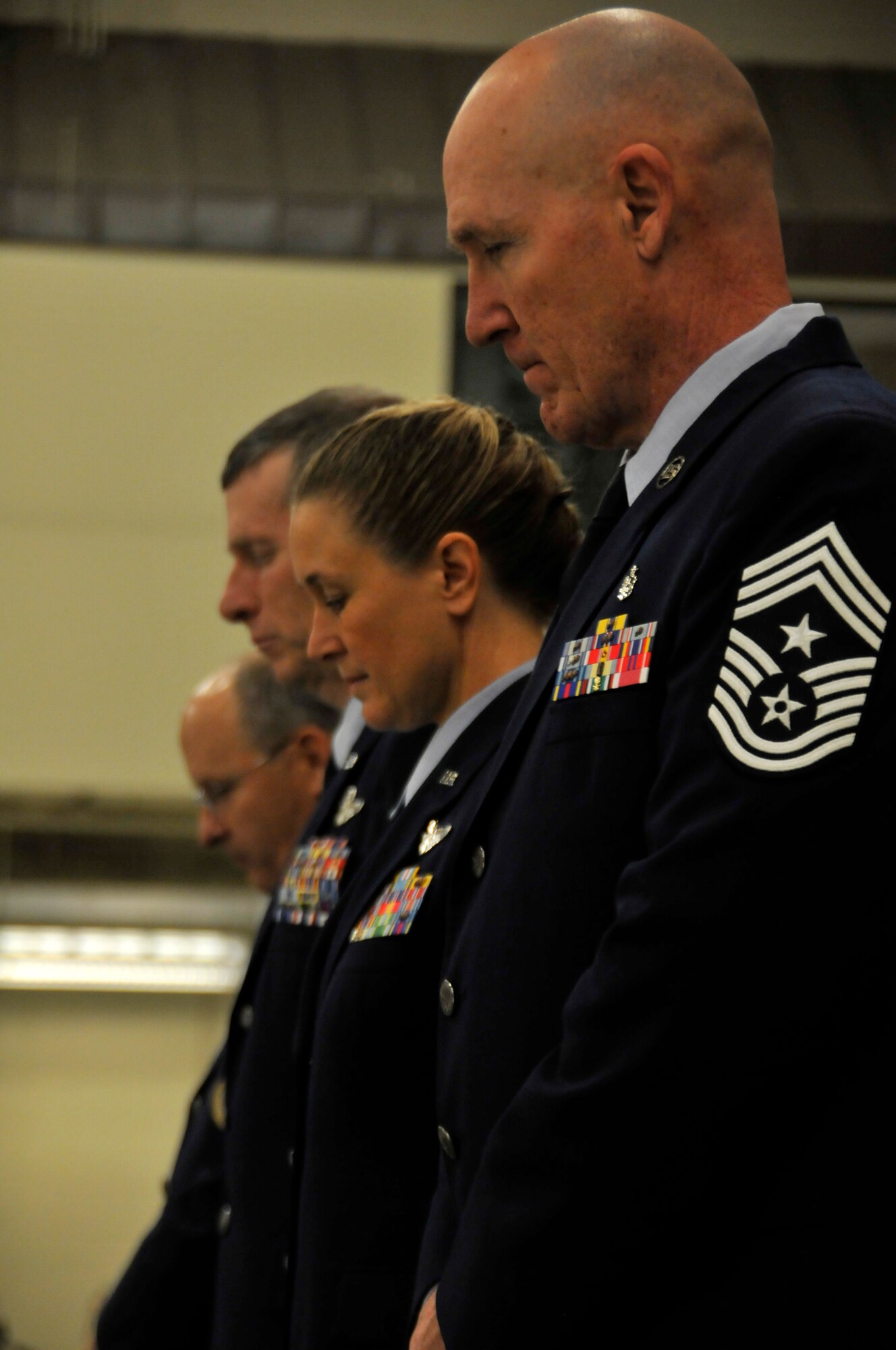 From left: Brig. Gen. Dwight Balch, Arkansas Air National Guard commander; Col. Mark Anderson, outgoing 188th Wing commander; Col. Bobbi Doorenbos, incoming wing commander; and Chief Master Sgt. Stephen Bradley, 188th Wing command chief, bow their heads during the invocation by Lt. Col. Herb Hodde, 188th chaplain, during a wing change of command ceremony Jan. 11 at Ebbing Air National Guard Base, Fort Smith, Ark. Anderson relinquished command of the 188th to Doorenbos during the ceremony. (U.S. Air National Guard photo by Staff Sgt. John Suleski/released)
