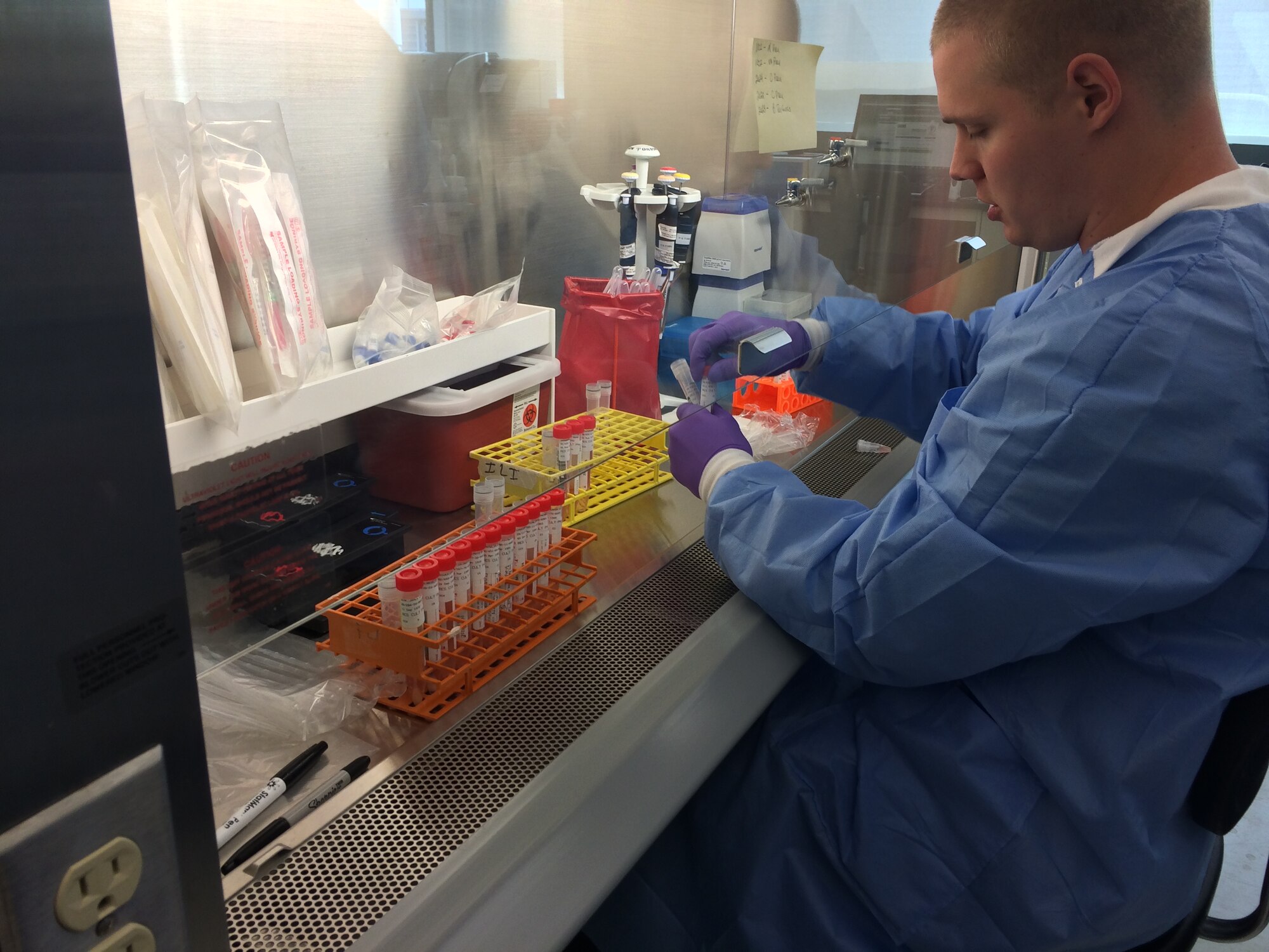 Matthew Couch, medical laboratory technician with the USAFSAM Epidemiology Laboratory, lyses respiratory viral specimens so that viral RNA can be extracted. (Contributed photo)
