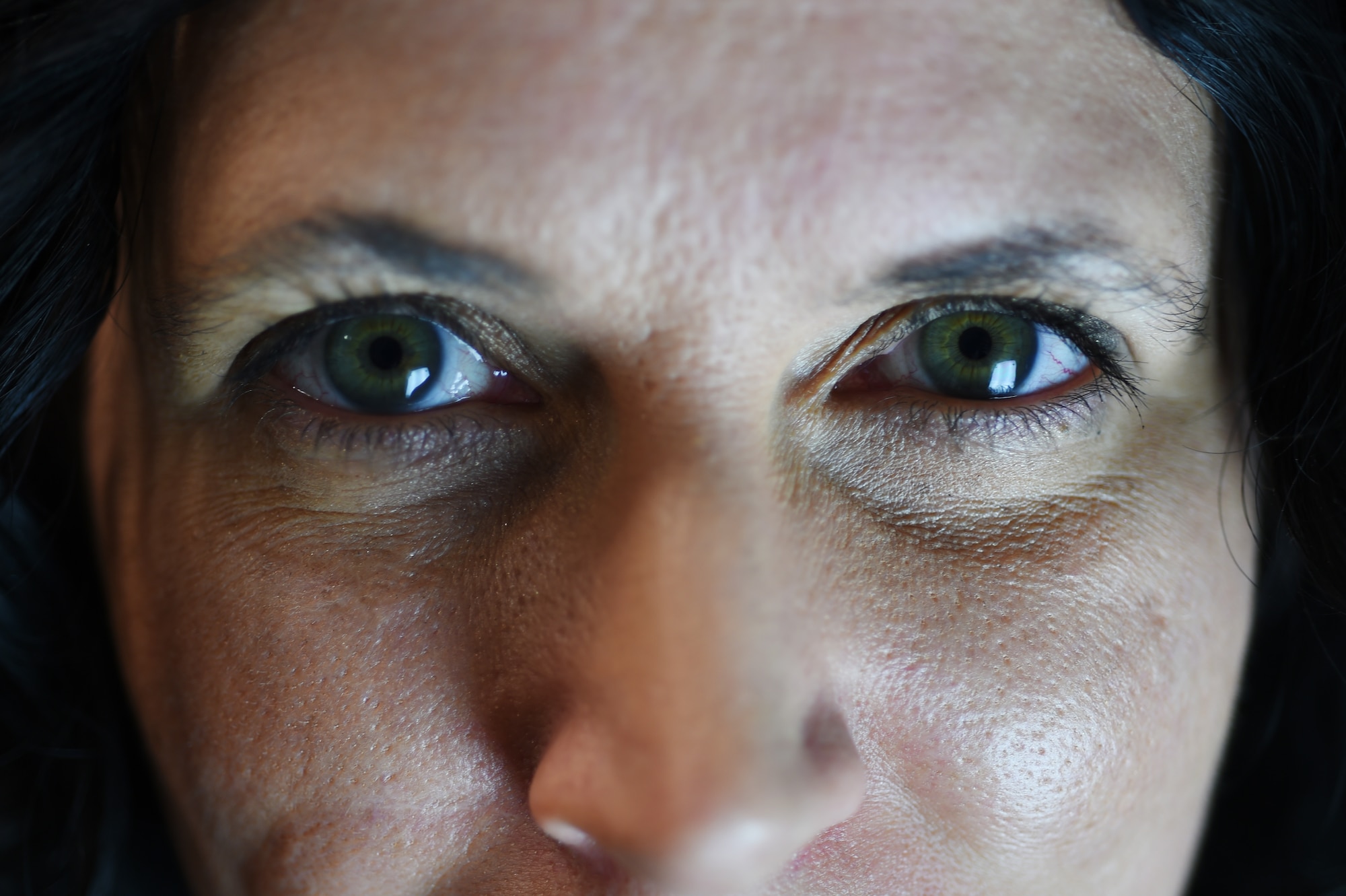 Kristina Da Silva E Silva, 423rd Medical Squadron occupational therapist, stares into her Seasonal affective disorder lamp at her office on RAF Alconbury, England, Jan. 16, 2015. The SAD lamp is a light therapy device which simulates the intake of Vitamin D the human body typically gets from natural sunlight. (U.S. Air Force photo by Staff Sgt. Jarad A. Denton/Released)