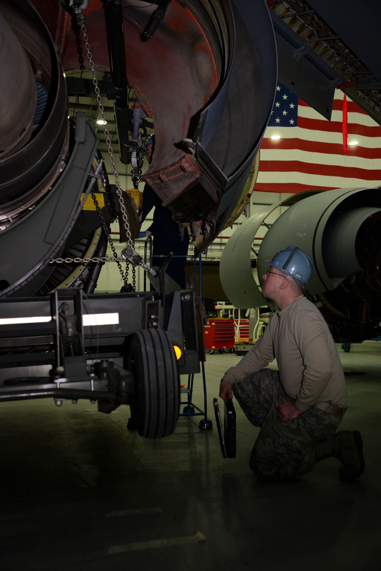 U.S. Air Force Staff Sgt. David Manning, 100th Maintenance Squadron aerospace propulsion mechanic from Poultney, Vt., ensures the engine swap on a KC-135 Stratotanker goes smoothly Jan. 22, 2015, on RAF Mildenhall, England. Exchanging a damaged engine with an operational one on a KC-135 typically takes 48 hours to complete. (U.S. Air Force photo by Senior Airman Victoria H. Taylor/Released)