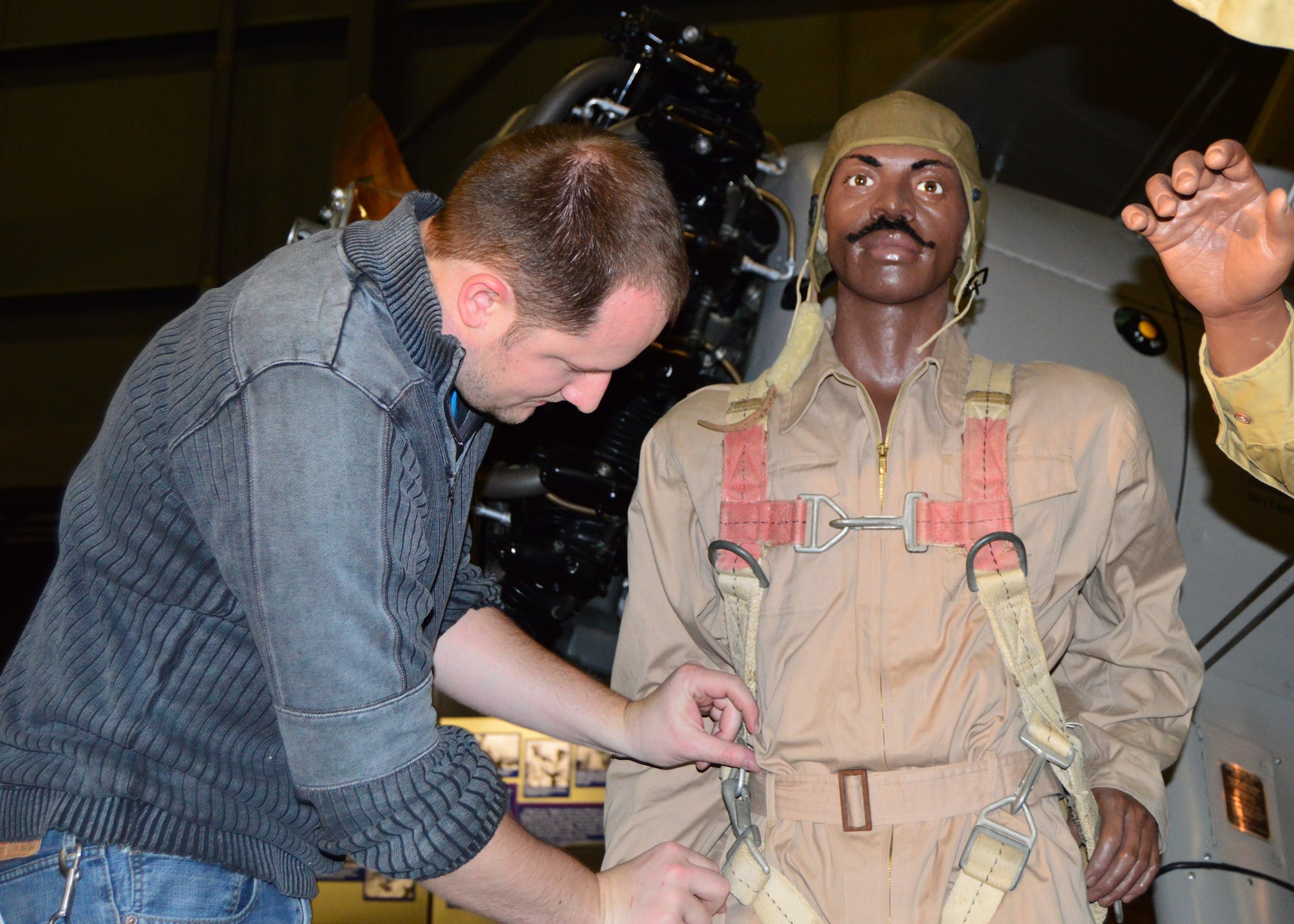 DAYTON, Ohio -- Exhibits Specialist Luke Maynard works on installing the mannequins in the Tuskegee Airmen diorama in the WWII Gallery at the National Museum of the U.S. Air Force. (U.S. Air Force photo) 

