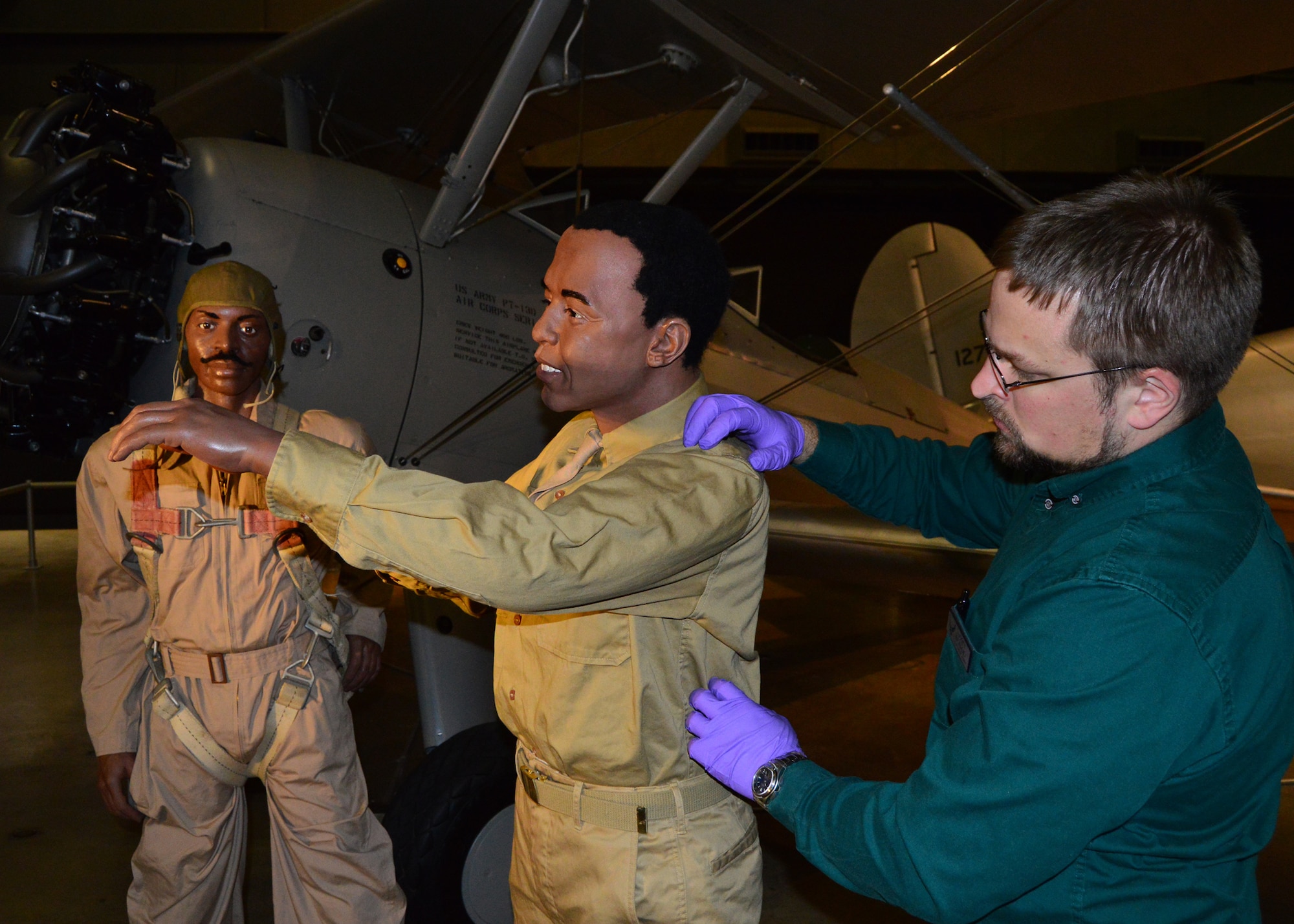 DAYTON, Ohio -- Museum Curator Scott Bradley works on installing the mannequins in the Tuskegee Airmen diorama in the WWII Gallery at the National Museum of the U.S. Air Force. (U.S. Air Force photo) 
