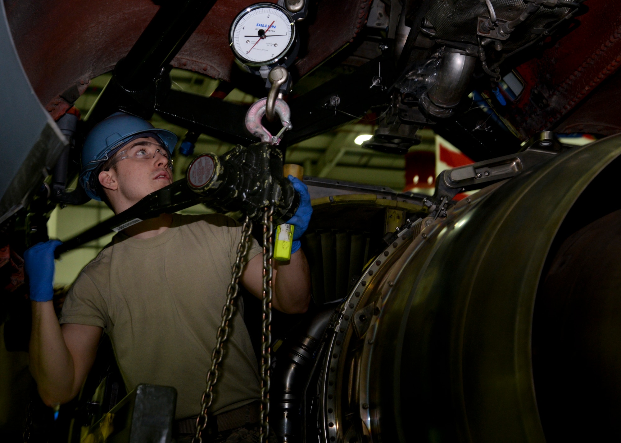U.S. Air Force Airman 1st Class Joshua Heffernan, 100th Maintenance Squadron aerospace propulsion apprentice from Syracuse, N.Y., hoists the engine for a KC-135 Stratotanker during an engine swap Jan. 22, 2015, on RAF Mildenhall, England. Exchanging a damaged engine with an operational one on a KC-135 typically takes 48 hours to complete. (U.S. Air Force photo by Senior Airman Victoria H. Taylor/Released)