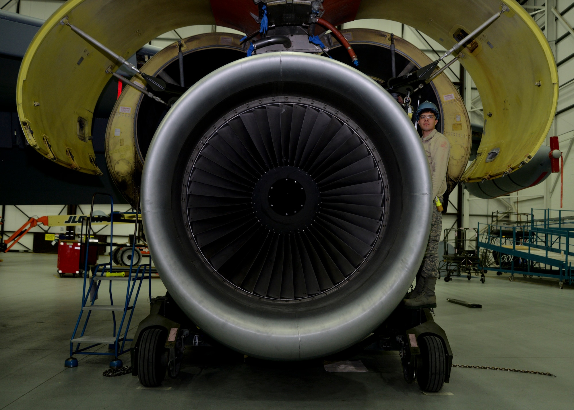 U.S. Air Force Airman 1st Class Michael Vasquez, 100th Maintenance Squadron aerospace propulsion apprentice from Denver, awaits direction during an engine swap on a KC-135 Stratotanker Jan. 22, 2015, on RAF Mildenhall, England. Exchanging a damaged engine with an operational one on a KC-135 typically takes 48 hours to complete. (U.S. Air Force photo by Senior Airman Victoria H. Taylor/Released)