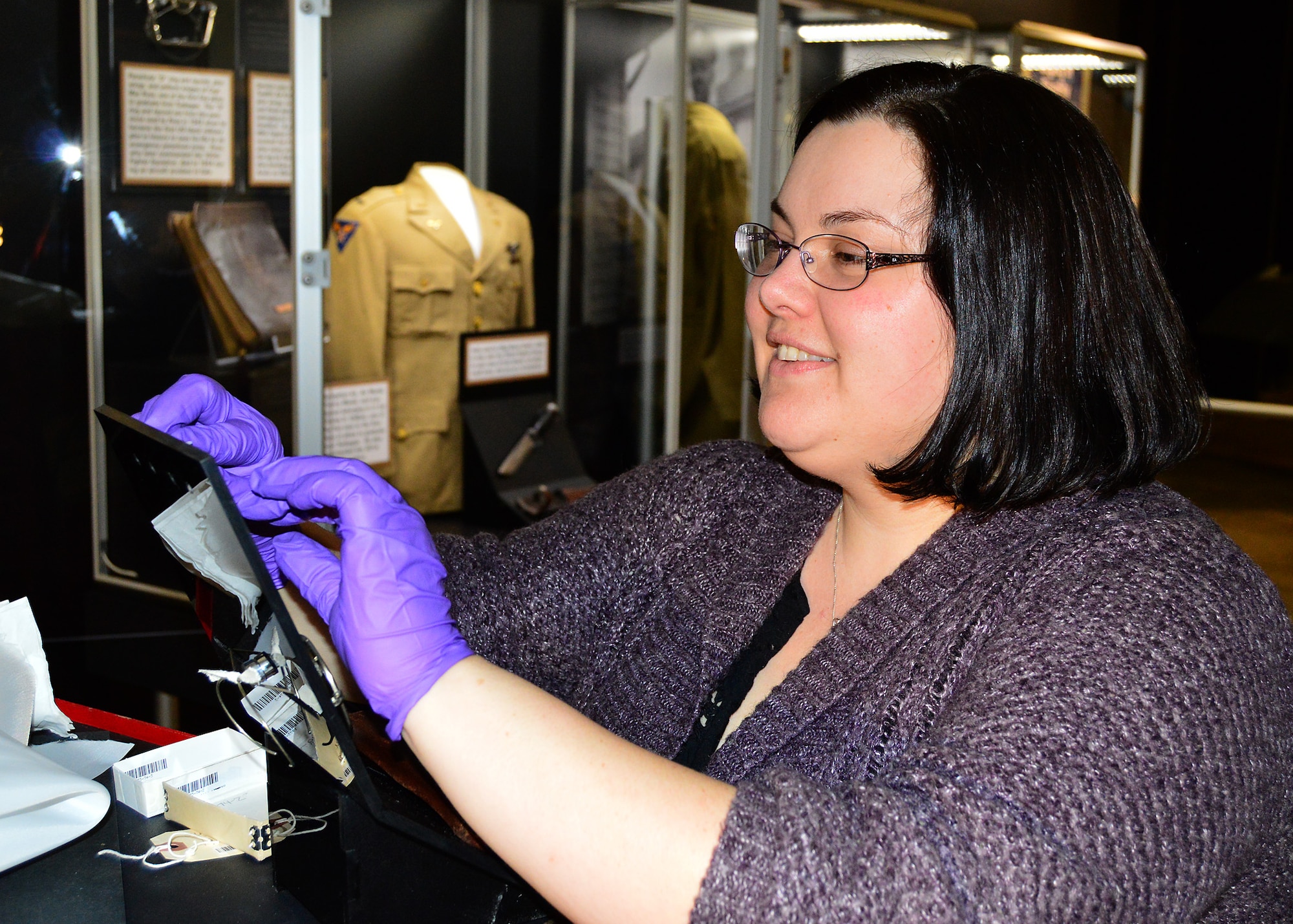 DAYTON, Ohio -- Museum Curator Jennifer Myers works on items in the Tuskegee Airmen Exhibit  in the WWII Gallery at the National Museum of the U.S. Air Force.(U.S. Air Force photo) 
