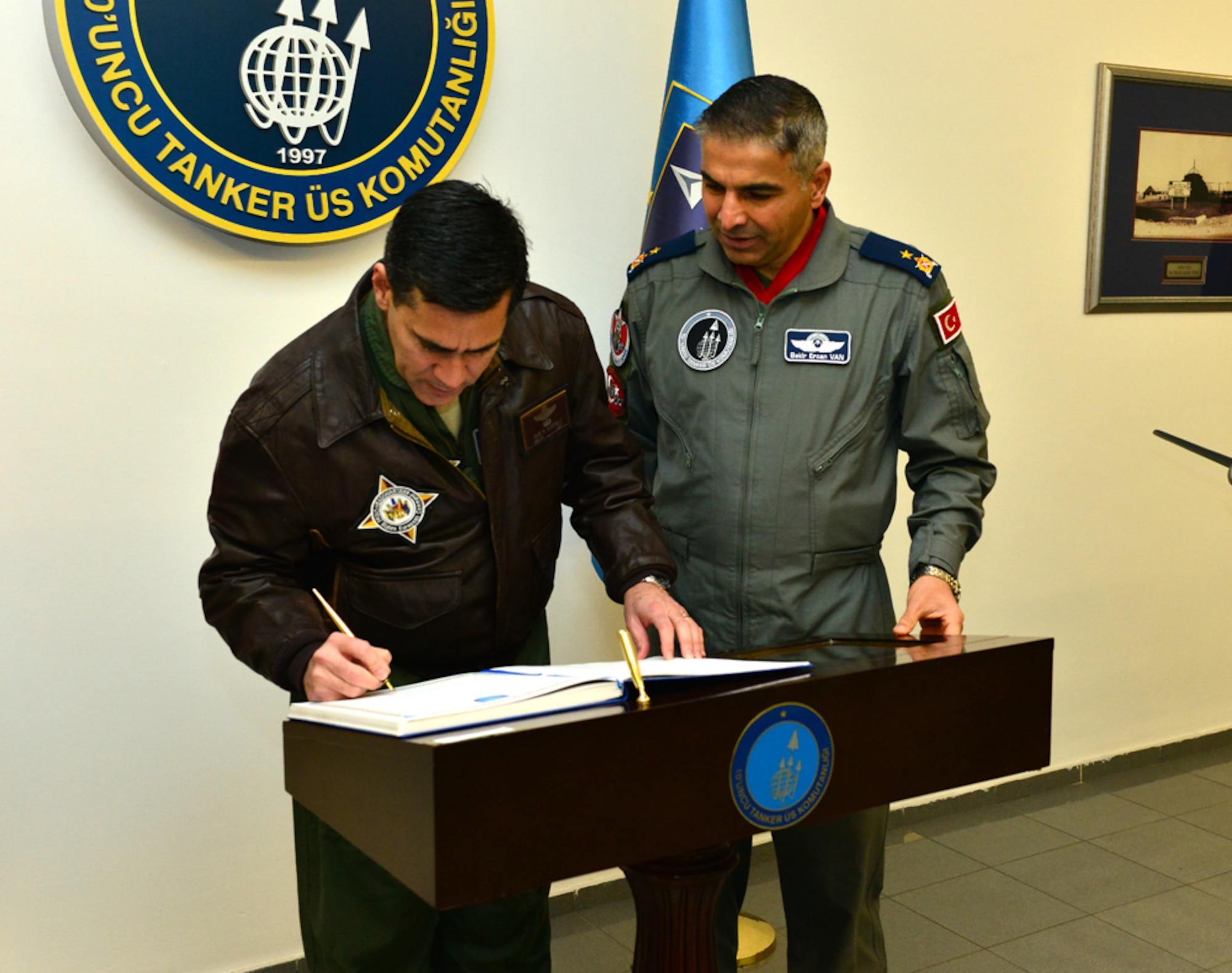 Brig. Gen. Marc H. Sasseville, senior defense official and defense attaché, Office of Defense Cooperation Turkey, U.S. European Command, Ankara, Turkey, signs the 10th Tanker Base honor book during a one-day base visit Jan. 20, 2015, at Incirlik Air Base, Turkey. As the senior defense official, Sasseville manages all aspects of security assistance and security cooperation programs necessary to sustain the military-to-military relationship between the U.S. and Turkey. (U.S. Air Force photo by Senior Airman Michael Battles/Released)