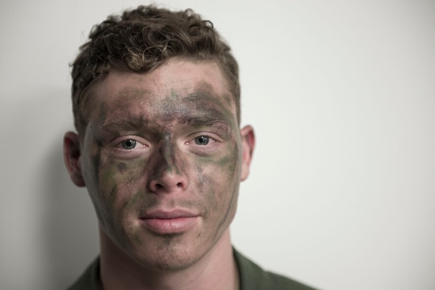 Senior Airman Nathanial Bennett, 36th Airlift Squadron loadmaster, poses after survival, evasion, resistance and escape training at Camp Fuji, Japan, Jan. 16, 2015. In the exercise scenario, Bennett and three of aircrew members crashed behind enemy lines and had to find their way safely to a rescue team while evading dozens of Marines and Sailors. (U.S. Air Force photo by Staff Sgt. Cody H. Ramirez/Released)