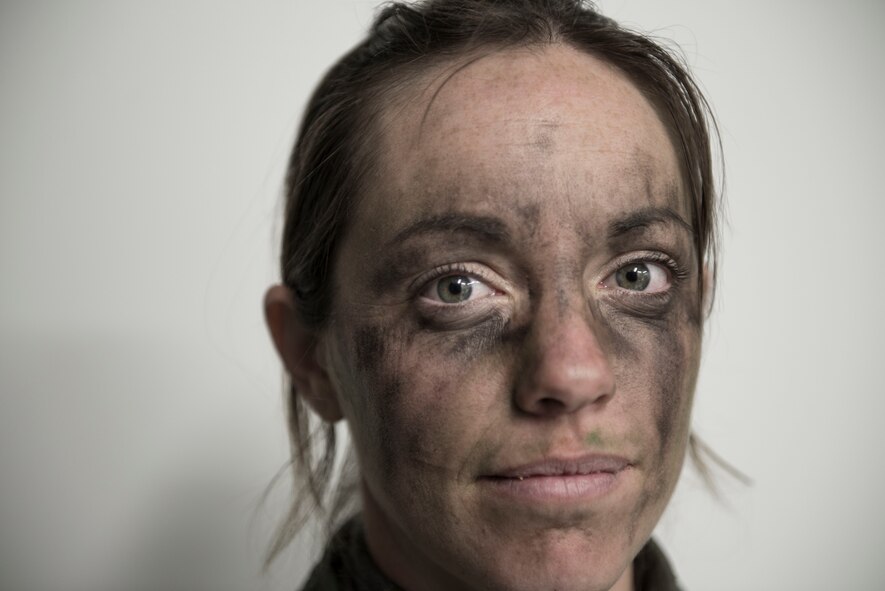 Capt. Kerri Morris, 36th Airlift Squadron C-130 Hercules pilot, poses after survival, evasion, resistance and escape training at Camp Fuji, Japan, Jan. 16, 2015. In the exercise scenario, Morris and three of aircrew members crashed behind enemy lines and had to find their way safely to a rescue team while evading dozens of Marines and Sailors. (U.S. Air Force photo by Staff Sgt. Cody H. Ramirez/Released)