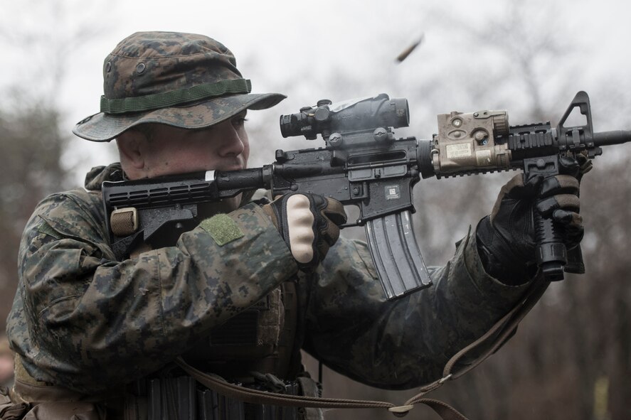 A Marine with the 1st Batallion, 1st Marines, fires his weapon (loaded with blanks) toward escaping aircrew members during joint training at Camp Fuji, Japan, Jan. 16, 2015. The Marines, who were acting as enemy aggressors searching for Air Force aircrew during survival, evasion, resistance and escape training, also practiced their small arms engagement with a “rescue” team of Marines. (U.S. Air Force photo by Staff Sgt. Cody H. Ramirez/Released)