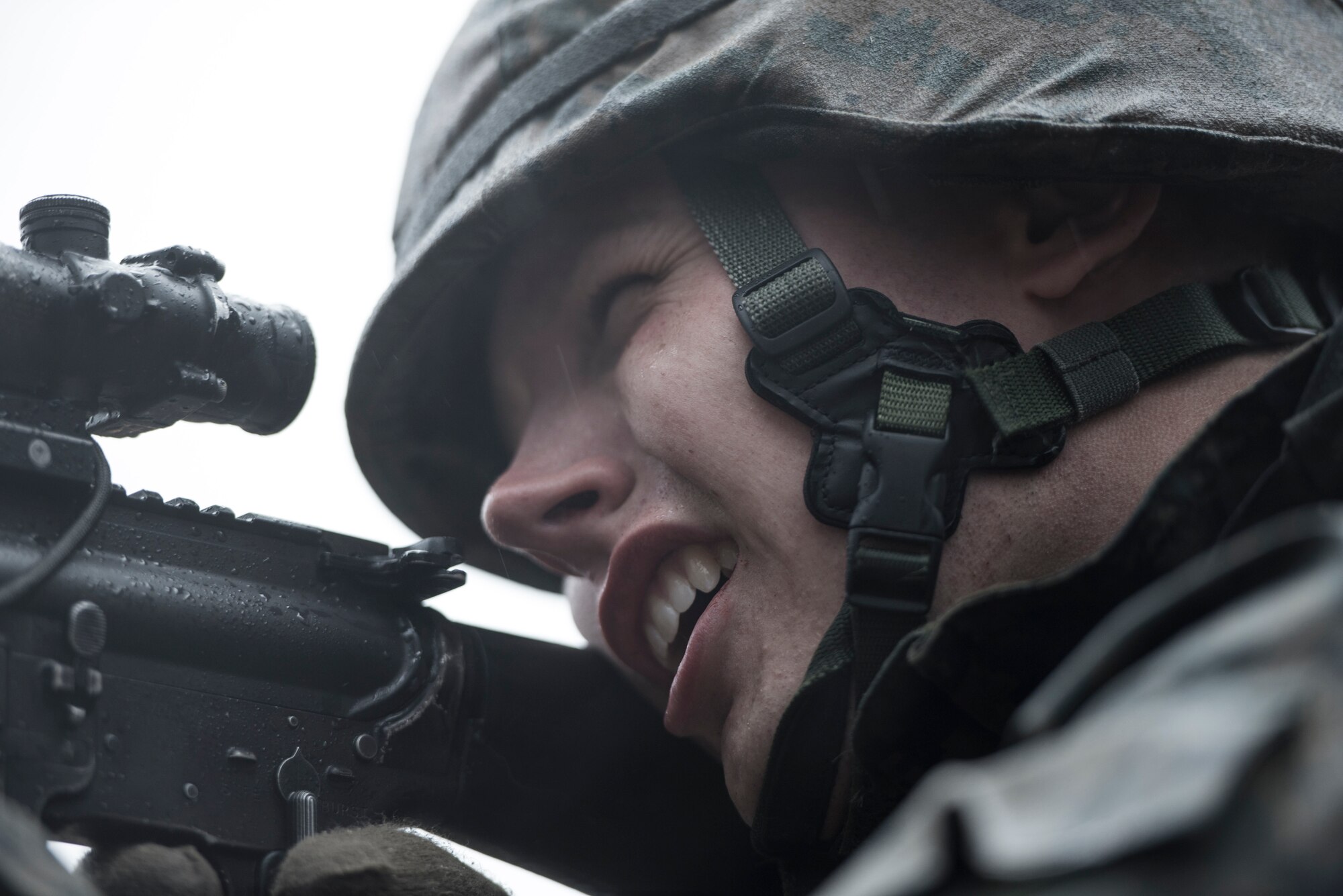 A Marine with the 1st Batallion, 1st Marines, fires his weapon (loaded with blanks) toward escaping aircrew members during joint training at Camp Fuji, Japan, Jan. 16, 2015. The Marines, who were acting as enemy aggressors searching for Air Force aircrew during survival, evasion, resistance and escape training, also practiced their small arms engagement with a “rescue” team of Marines. (U.S. Air Force photo by Staff Sgt. Cody H. Ramirez/Released)