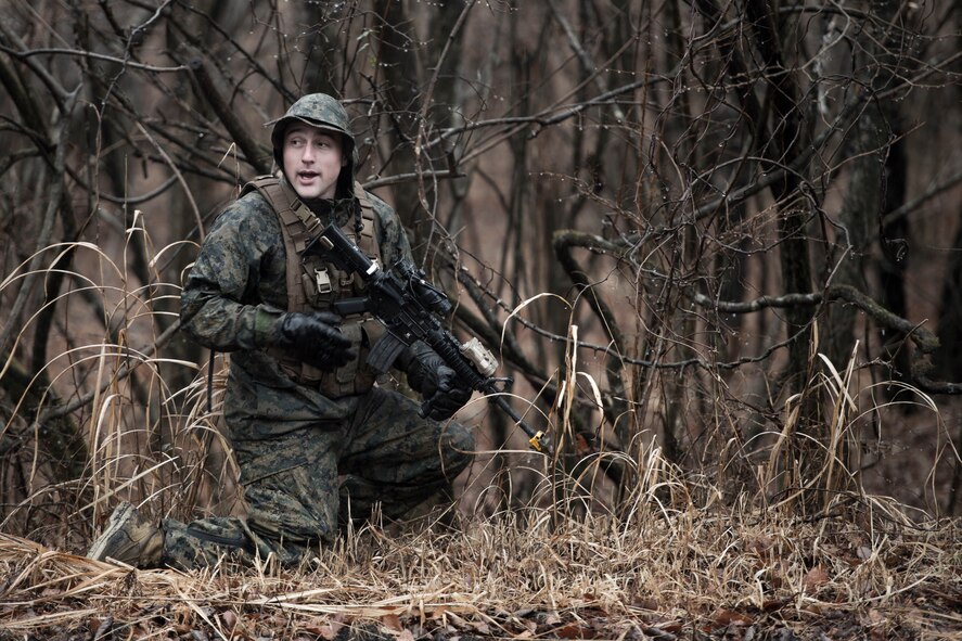 A Marine with the 1st Batallion, 1st Marines, shouts to others amidst a simulated small-arms exchange during survival, evasion, resistance and escape training at Camp Fuji, Japan, Jan. 16, 2015.  Marines and Sailors acted as enemy aggressors, practicing their patrolling techniques, while searching for Air Force aircrew, who were simultaneously training their SERE techniques. (U.S. Air Force photo by Staff Sgt. Cody H. Ramirez/Released)