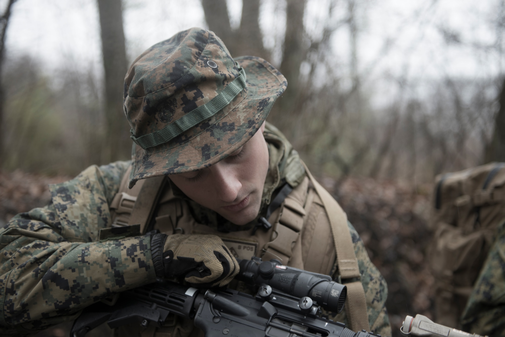 A Marine with the 1st Batallion, 1st Marines, checks to see if his weapon is loaded during survival, evasion, resistance and escape training at Camp Fuji, Japan, Jan. 16, 2015. Marines and Sailors assisted the 36th Airlift Squadron with their training, playing the role of aggressors, hunting the aircrew. (U.S. Air Force photo by Staff Sgt. Cody H. Ramirez/Released)