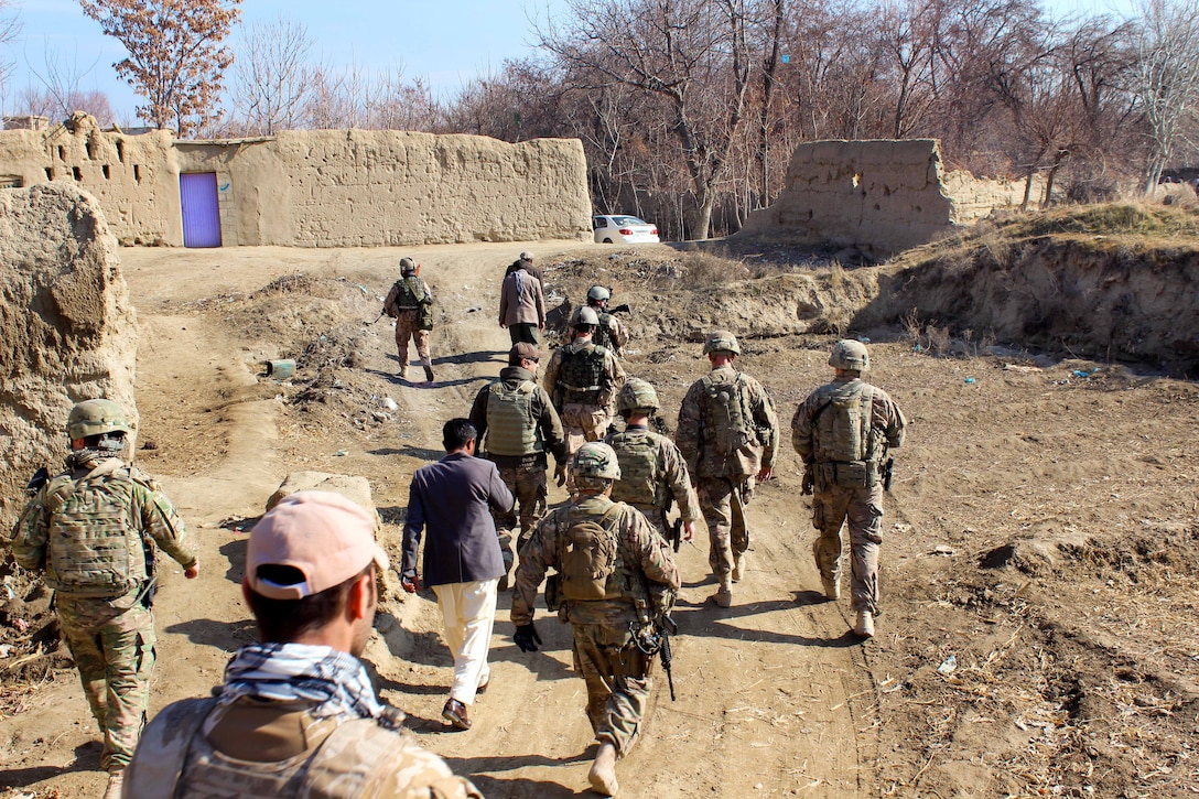 U.S. Army Lt. Col. James James, center right, along with U.S. and Czech soldiers patrol through a village to attended a shura, and cut the ribbon on the Bagram Canal Project near Bagram Airfield, Afghanistan, Jan. 17, 2015. James is the commander of Task Force Sabre, 2nd Squadron, 3rd Cavalry Regiment, 