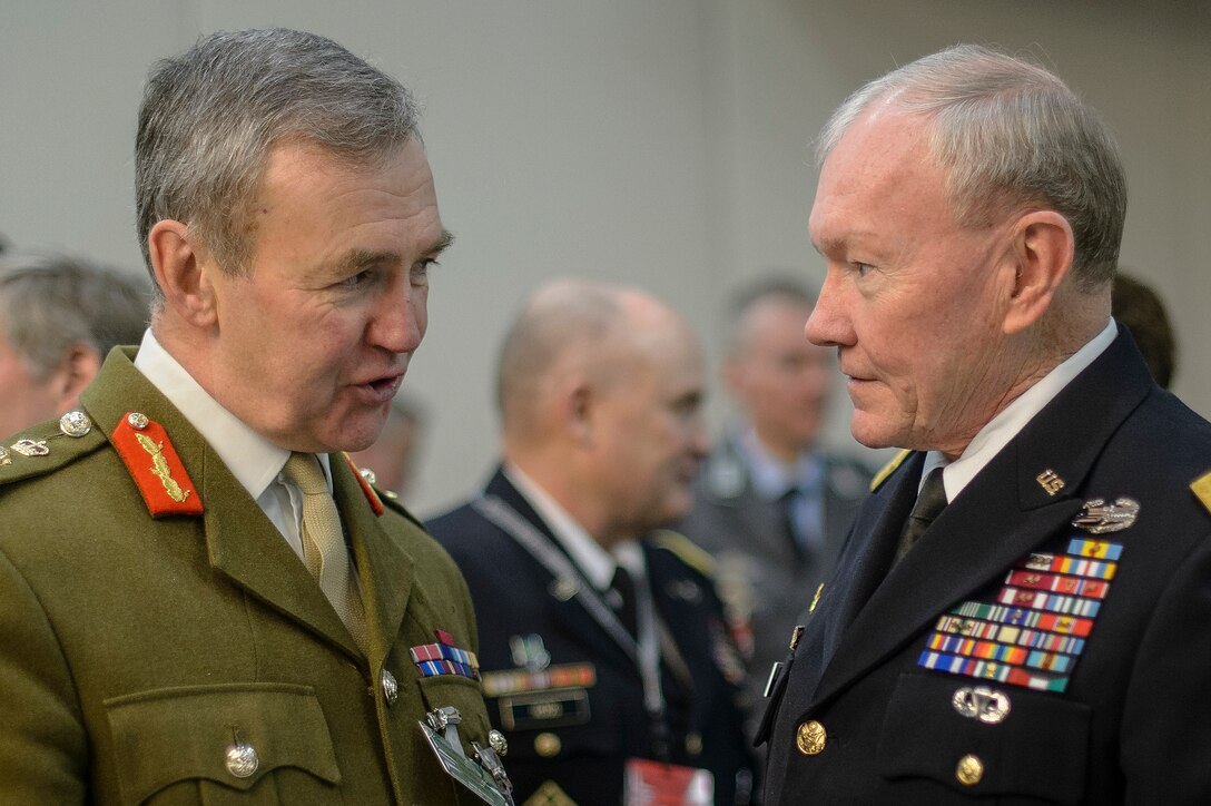 U.S. Army Gen. Martin E. Dempsey, chairman of the Joint Chiefs of Staff, talks with British Army Gen. Nicholas Houghton, chief of Britain's defense staff, in between NATO’s Military Committee meetings in Brussels, Jan. 22, 2015. 