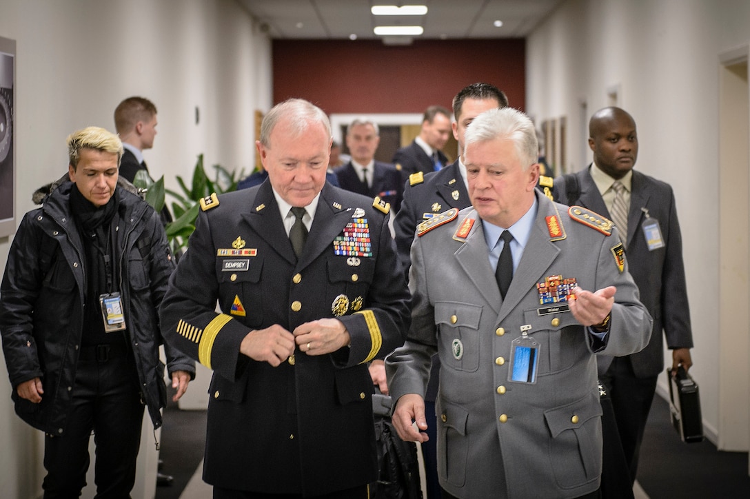 German Defense Chief Volker Wieker and U.S. Army Gen. Martin E. Dempsey, chairman of the Joint Chiefs of Staff, talk in between meetings at the NATO military committee and chiefs of defense conference in Brussels, Jan. 21, 2015. 