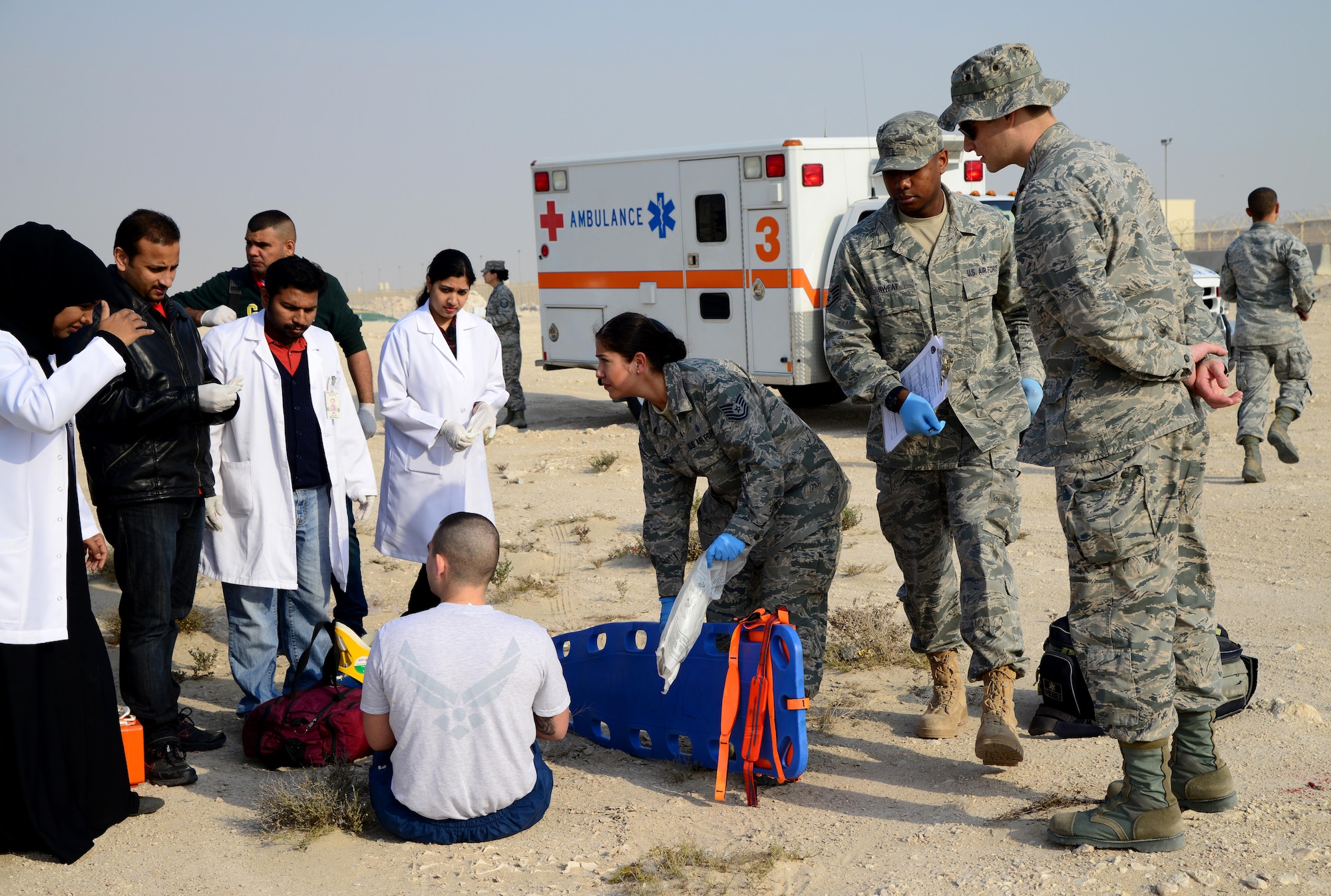U.S. Air Force and Qatari medical personnel respond to the scene of a simulated motor vehicle accident during a joint training event, Jan. 18, 2015, at Al Udeid Air Base, Qatar. The training required 379th Expeditionary Medical Group Airmen and Qatari medics to integrate and exchange knowledge that will help them jointly respond to real-world medical emergencies at Al Udeid. (U.S. Air Force photo by Senior Airman Kia Atkins)
