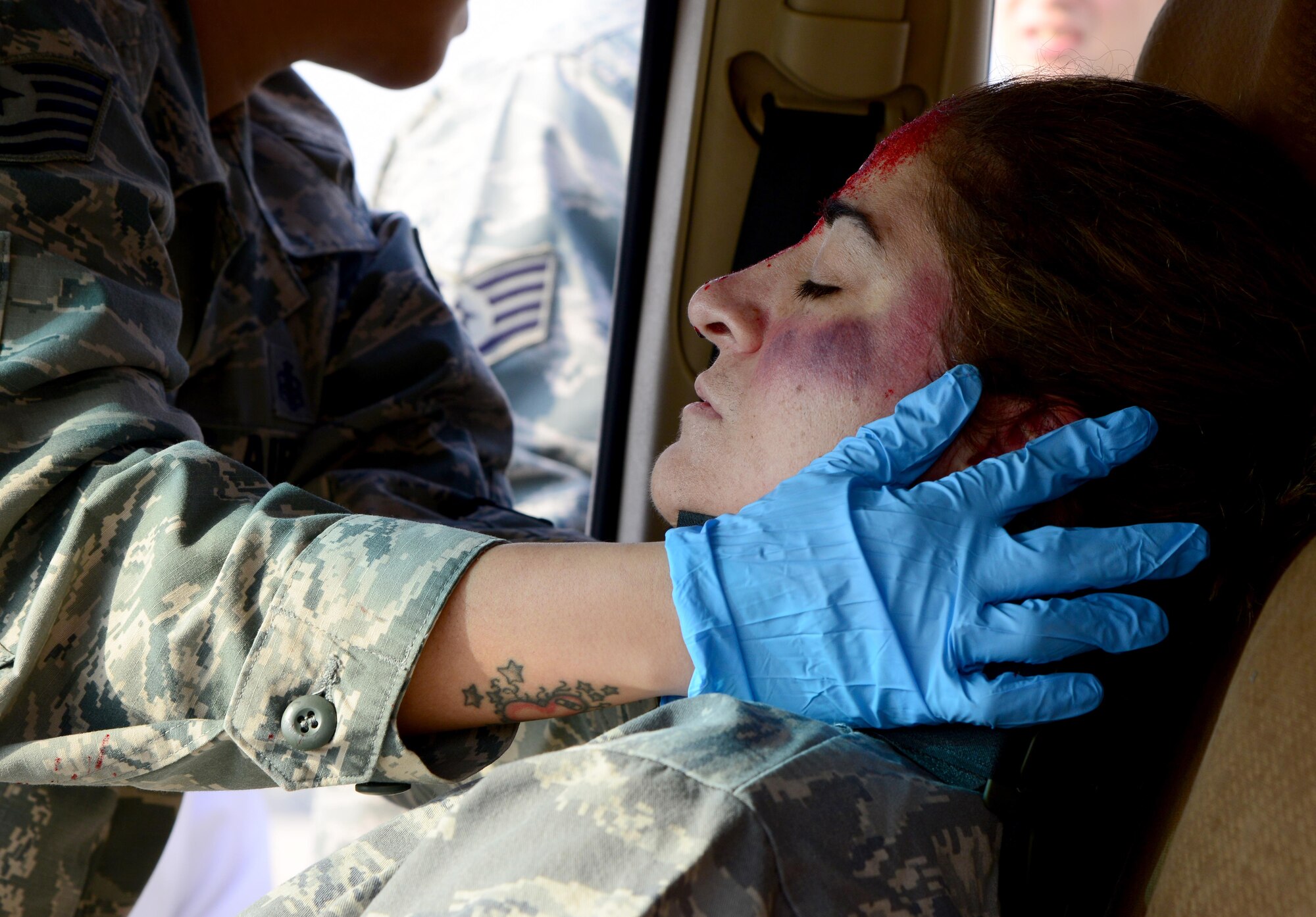 U.S. Air Force Tech. Sgt. Brenda Ayala, 379th Expeditionary Medical Operations Squadron, holds the neck of a simulated victim of a motor vehicle accident during a joint training event, Jan. 18, 2015, at Al Udeid Air Base, Qatar. The training required 379th Expeditionary Medical Group Airmen and Qatari medics to integrate and exchange knowledge that will help them jointly respond to real-world medical emergencies at Al Udeid. (U.S. Air Force photo by Senior Airman Kia Atkins)