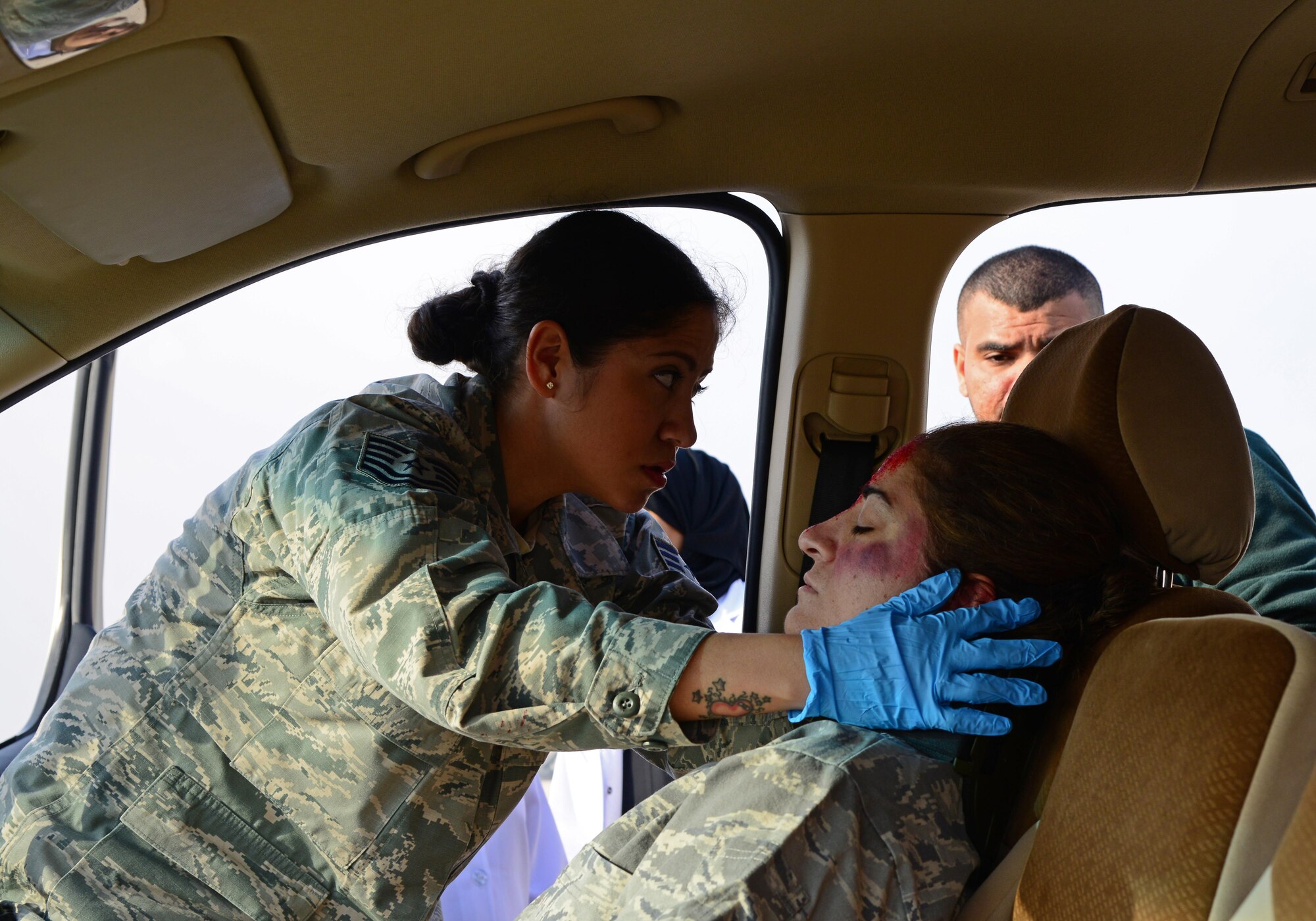 U.S. Air Force Tech. Sgt. Brenda Ayala, left, 379th Expeditionary Medical Operations Squadron, works alongside a Qatari medic to treat a simulated victim of a motor vehicle accident during a joint training event, Jan. 18, 2015, at Al Udeid Air Base, Qatar. The training required 379th Expeditionary Medical Group Airmen and Qatari medics to integrate and exchange knowledge that will help them jointly respond to real-world medical emergencies at Al Udeid. (U.S. Air Force photo by Senior Airman Kia Atkins)
