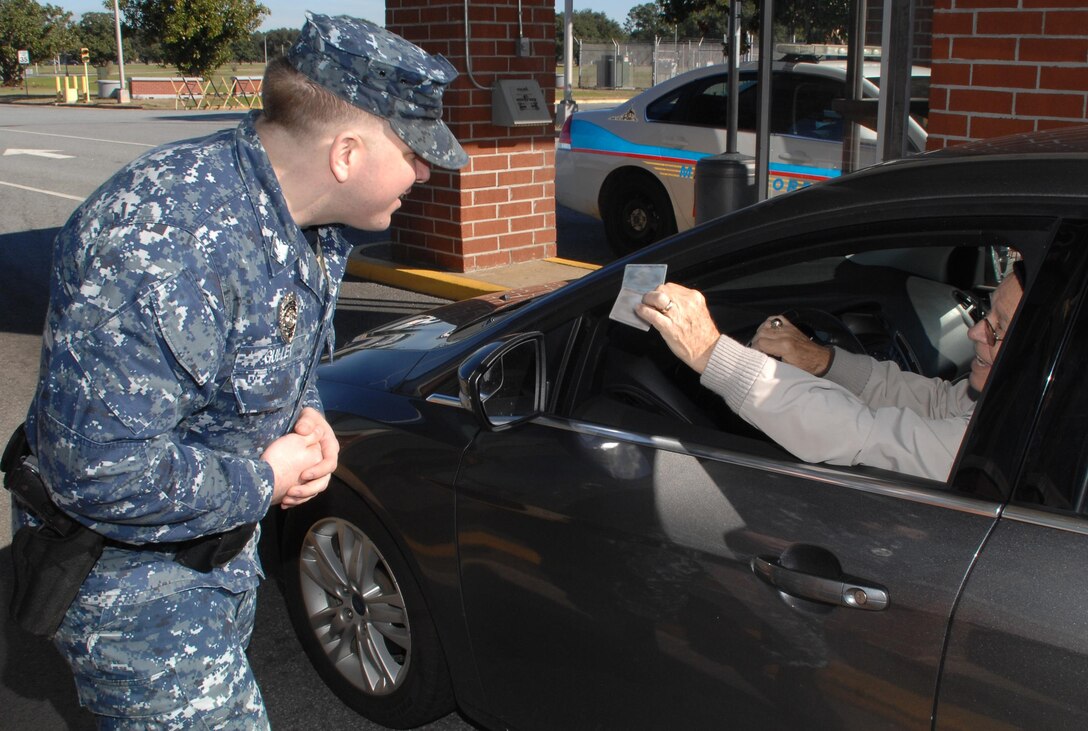 Petty Officer 2nd Class Joshua Gulley, security augmentation force augmentee, Marine Corps Logistics Base Albany, checks an identification card during SAF monthly training, here, recently. 