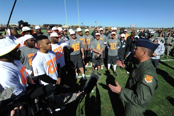 Brig. Gen. Scott Pleus, 56th Fighter Wing commander, speaks with National Football League Pro Bowl players during a Pro Bowl practice at Luke Air Force Base, Arizona, Jan. 22, 2015. Pleus spoke to the Pro Bowl players about the mission at Luke and thanked them for their support. (U.S. Air Force photo by Staff Sgt. Staci Miller)