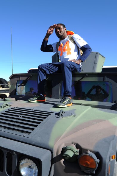 Robert Quinn, St. Louis Rams defense end assigned to Pro Bowl Team Irvin, poses on top of a Humvee after the Pro Bowl practice at Luke Air Force Base, Arizona, Jan. 22, 2015. Quinn and other Pro Bowl players mingled with Airmen and signed autographs after conducting a practice. (U.S. Air Force photo by Staff Sgt. Staci Miller)