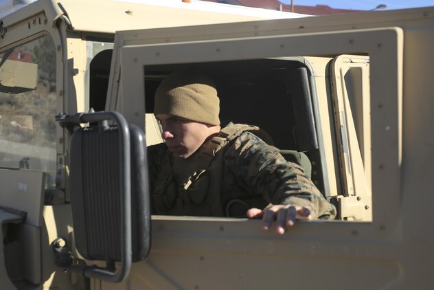 Private First Class Joel Licon-Banuelos, with Combat Logistics Battalion 26, Headquarters Regiment, 2nd Marine Logistics Group, climbs into a High Mobility Multipurpose Wheeled Vehicle before conducting a simulated convoy throughout the hills aboard Bridgeport, California, Jan. 14, 2015. The convoy consisted of four HMMWVs, each manned by a driver and an A-gunner, which led up into the hills and back down, ensuring that each driver knows how to properly handle the vehicle going up and down steeper terrain. (U.S. Marine Corps photo by Lance Cpl. Kaitlyn Klein/released)