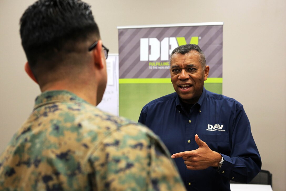 Alan Willingham, right, spoke with Marines about the importance of documenting any and all medical issues while in the Marine Corps during a Transition Resource Fair held, here, by the Personal and Professional Development Branch of Marine and Family Programs Jan. 22. 

Willingham is a transition service officer with the Disabled American Veterans organization.
