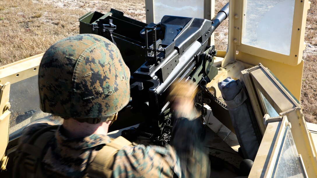 Lance Cpl. Brett Haertling, an intelligence analyst with Scout Platoon, 2nd Tank Battalion, and a Jackson, Miss. native, makes a fully loaded Mk 19 automatic grenade launcher ready to fire by pulling back on the charging handle during an annual qualification at training area G-7 aboard Camp Lejeune, N.C., Jan. 21, 2015. Marines with the unit launched grenades at various, non-moving targets between 400 and 1,500 meters away to prove their level of marksmanship.
