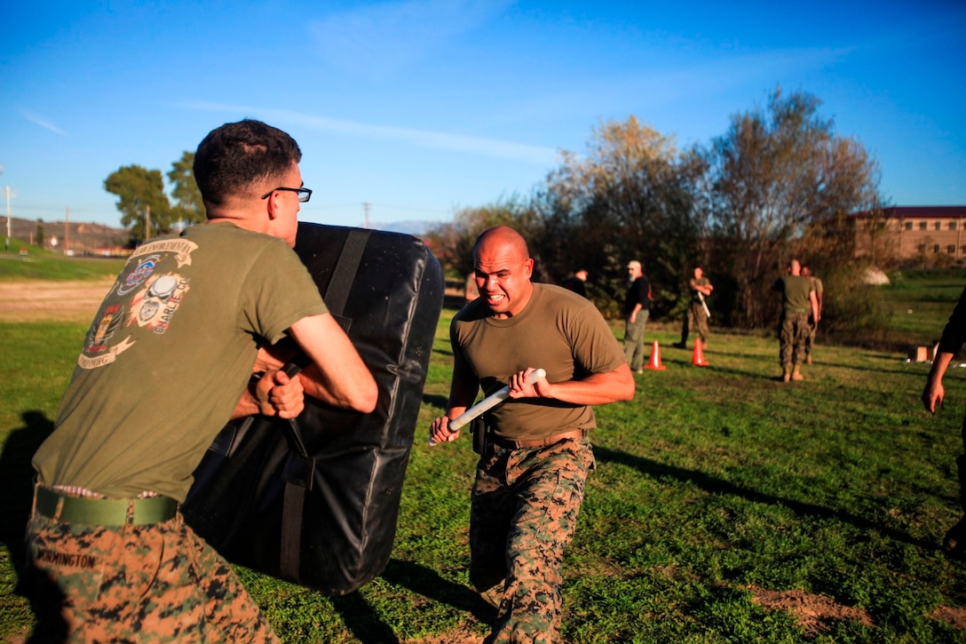 A Marine with 1st Law Enforcement Battalion negotiates a fight station after being exposed to Oleoresin Capsicum spray aboard Camp Pendleton, Calif., Jan. 14, 2015. The training was part of a two week long course designed to qualify new non-lethal weapons instructors.