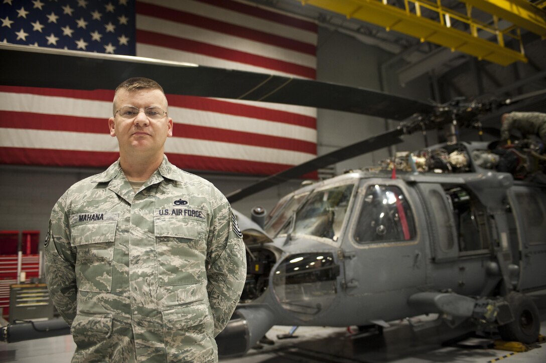 Tech. Sgt. Justin Mahana poses in front of an HH-60G Pave Hawk Jan. 20, 2015, at Nellis Air Force Base, Nev. On Jan. 6, 2015, Mahana pulled a middle-aged woman from a burning vehicle after overhearing her crash her SUV in a single-car accident in Lake Havasu, Ariz. Mahana is the 823rd Maintenance Squadron support section chief. (U.S. Air Force photo/Staff Sgt. Siuta B. Ika)
