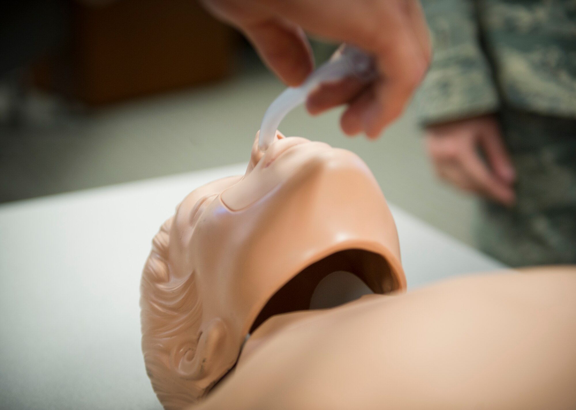 An Airman, from the 1st Special Operations Security Forces Squadron, practices inserting a nasopharyngeal airway on a mannequin during a Self-Aid Buddy Care Hands-On course at the security forces squadron on Hurlburt Field, Fla., Jan. 22, 2015. Inserting a nasopharyngeal airway on an individual provides an open airway, which is a critical life-saving maneuver. (U.S. Air Force photo/Senior Airman Krystal M. Garrett) 