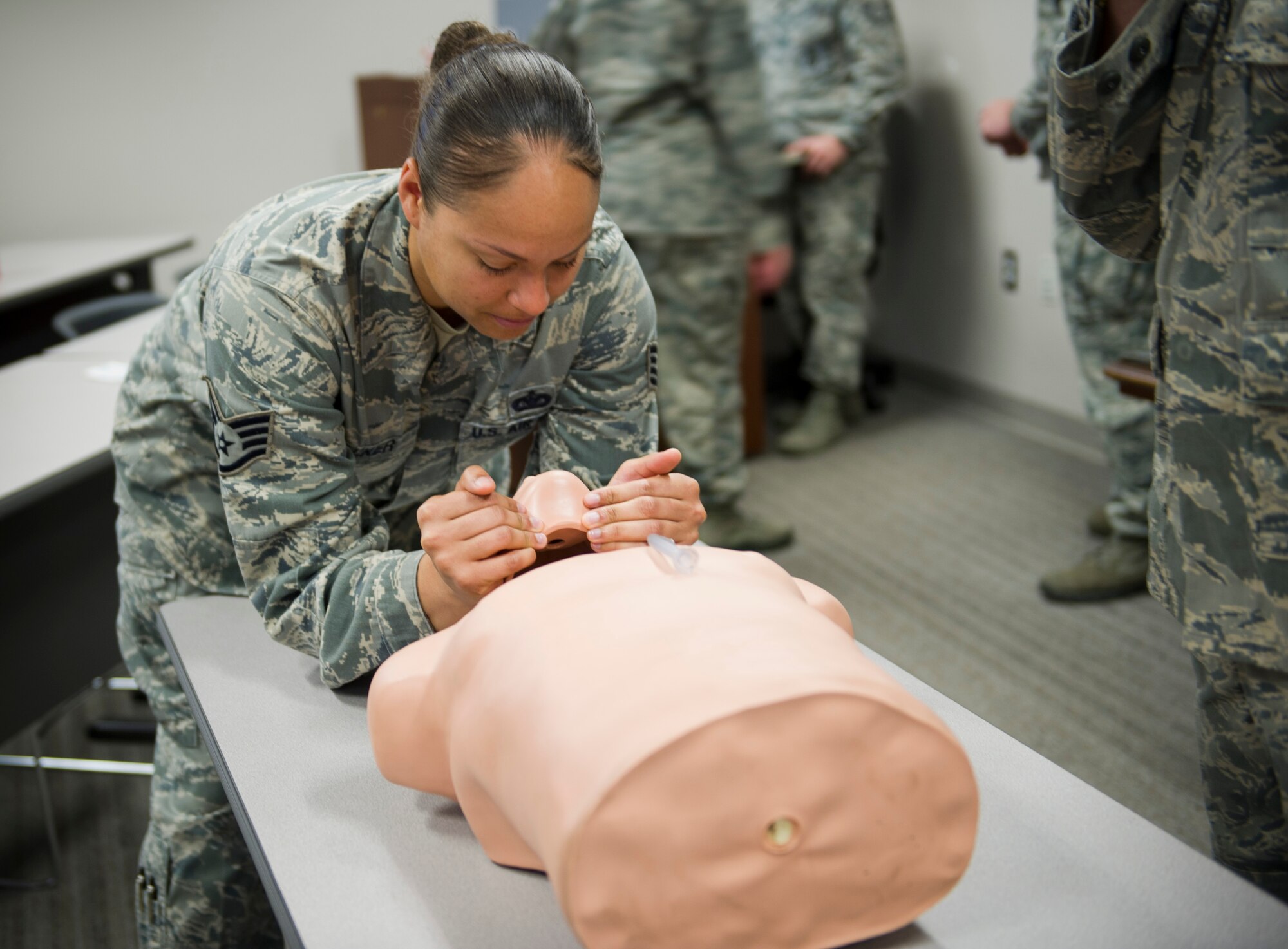 Staff Sgt. April Walker, 1st Special Operations Security Forces Squadron military working dog trainer, performs a head-tilt chin-lift on a mannequin during a Self-Aid Buddy Care Hands-On course at the security forces squadron on Hurlburt Field, Fla., Jan. 22, 2015. The head-tilt chin-lift technique cannot be performed if a person has a suspected spinal injury. (U.S. Air Force photo/Senior Airman Krystal M. Garrett)