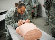 Staff Sgt. April Walker, 1st Special Operations Security Forces Squadron military working dog trainer, performs a head-tilt chin-lift on a mannequin during a Self-Aid Buddy Care Hands-On course at the security forces squadron on Hurlburt Field, Fla., Jan. 22, 2015. The head-tilt chin-lift technique cannot be performed if a person has a suspected spinal injury. (U.S. Air Force photo/Senior Airman Krystal M. Garrett)