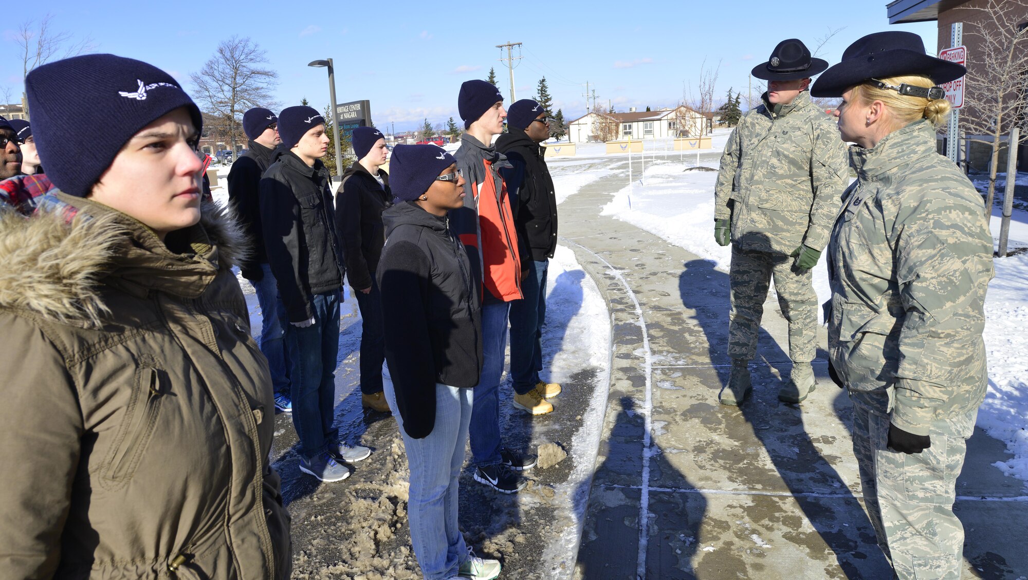 Tech. Sergeants Katie L. Badowski and Gregory A. Gresham, military training instructors assigned to the 433rd Training Squadron, Lackland Air Force Base, T.X. prepare trainees for lunch at the Niagara Falls Air Reserve Station, N.Y. Jan. 10, 2015. Badowski and Gresham were here to inform base personnel about MTI duty.
