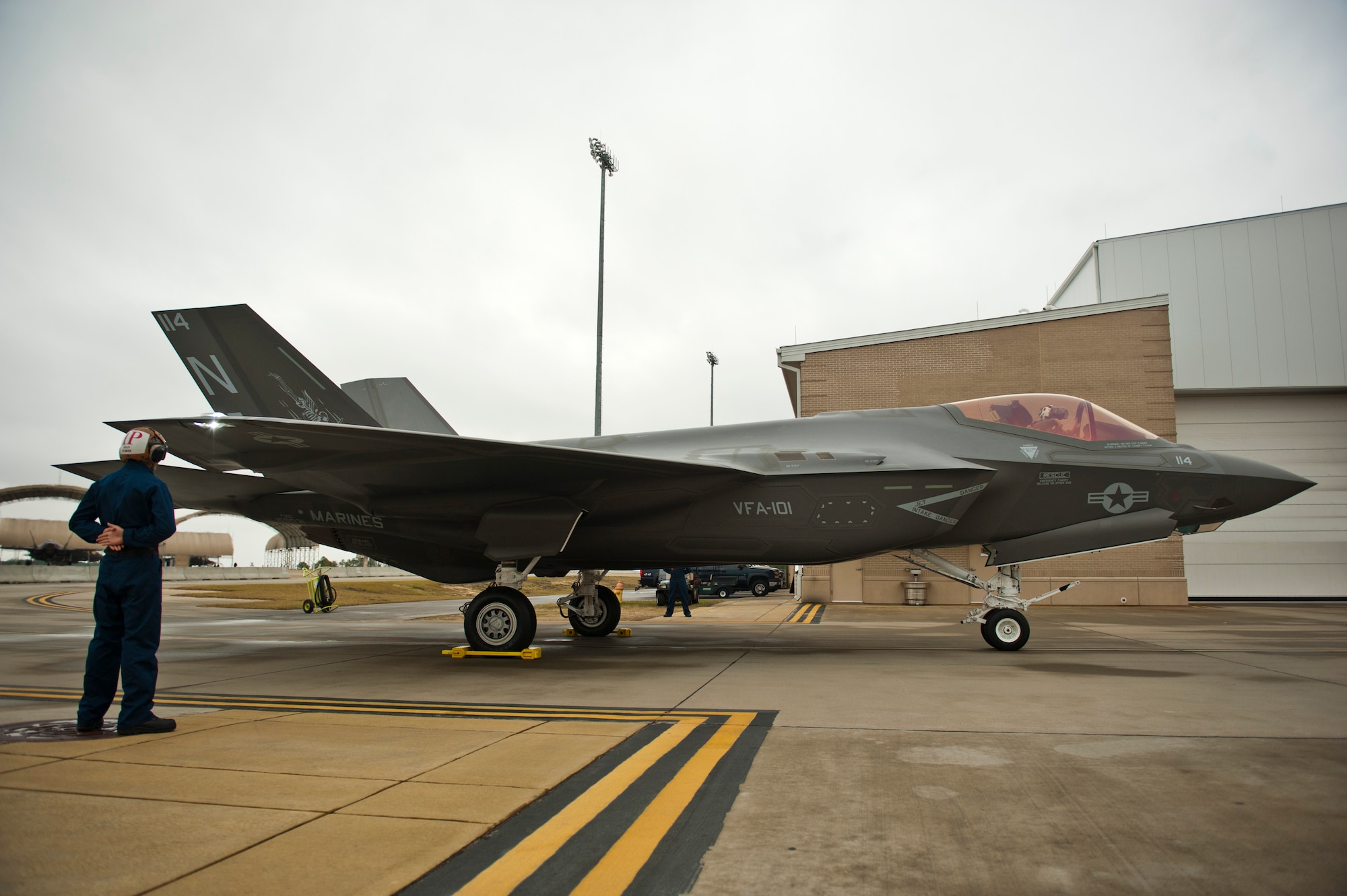 U.S. Marine Lt. Col. J.T. “Tank” Ryan, Marine Fighter Attack Training Squadron 501 detachment commander and F-35 pilot, delivers the first Marine Corps F-35C Lightning II carrier variant to Navy Attack Fighter Squadron 101 on Eglin Air Force Base, Fla., Jan. 13, 2015. Ryan flew the aircraft from the Lockheed Martin plant, Fort Worth, Texas, as the first of five Marine Corps F-35C model aircraft to be delivered to the VFA-101. The F-35C model brings 25% more range and a bigger weapons bay.  It also allows the Marine Corps to fly aboard Navy aircraft carriers, which continues an effective and long-standing tactical air integration program between the Navy and Marine Corps. (U.S. Air Force photo/Staff Sgt. Marleah Robertson)