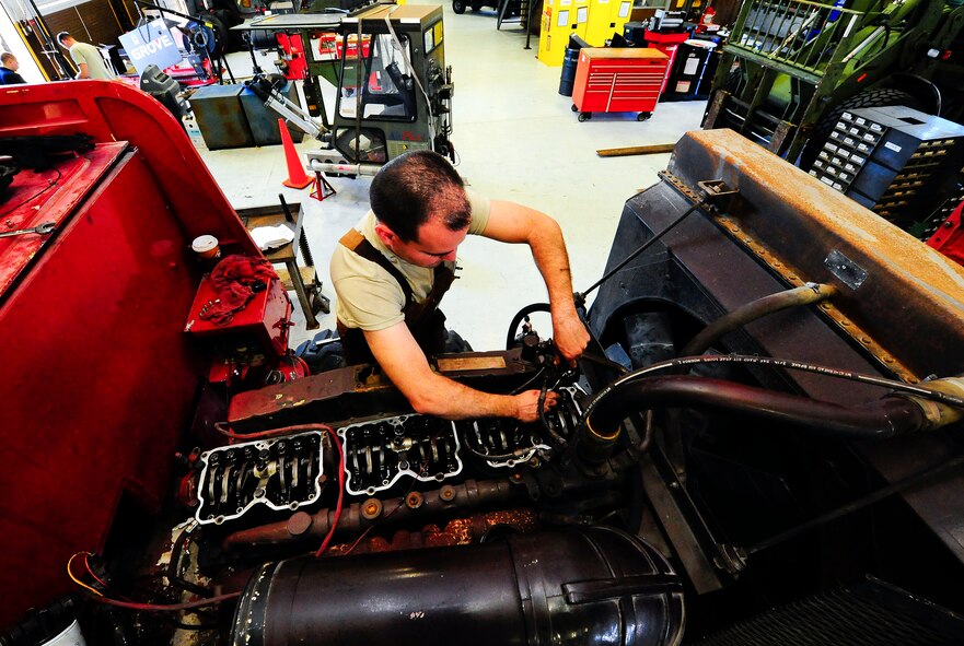 Staff Sgt. Nicholas Cawley, 1st Special Operations Logistics Readiness Squadron vehicle equipment journeyman, fixes the water pump on a fire truck at Hurlburt Filed, Fla., Jan. 21, 2015. 1SOLRS provides maintenance for vehicles such as humvees, firetrucks and K-loaders. (U.S. Air Force photo/Airman 1st Class Andrea Posey)