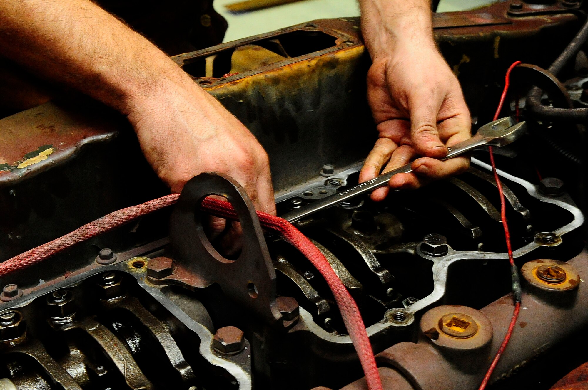 Staff Sgt. Nicholas Cawley, 1st Special Operations Logistics Readiness Squadron vehicle equipment journeyman, fixes the water pump on a fire truck at Hurlburt Filed, Fla., Jan. 21, 2015. 1SOLRS provides maintenance for government vehicles around Hurlburt. (U.S. Air Force photo/Airman 1st Class Andrea Posey)