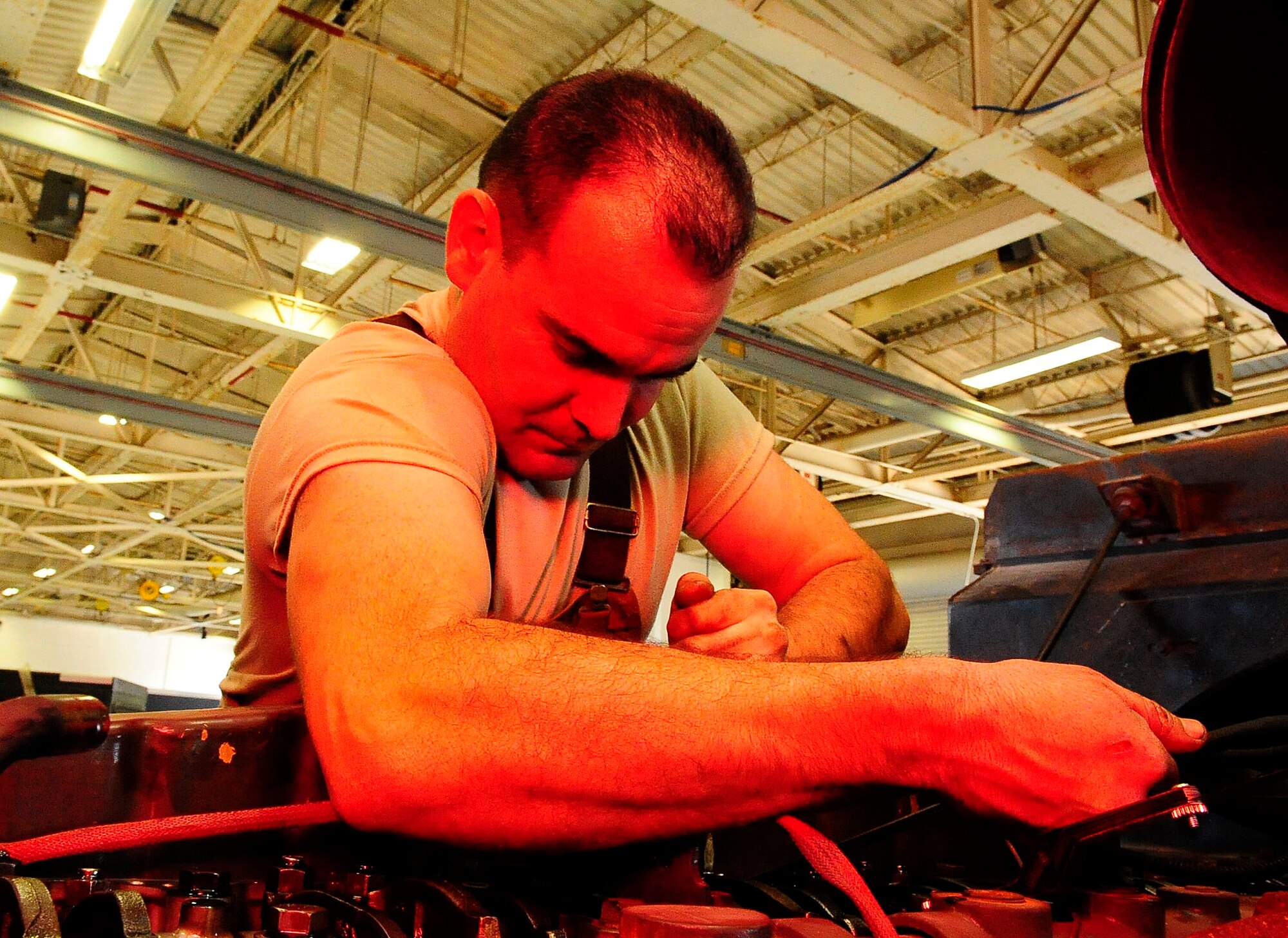 Staff Sgt. Nicholas Cawley, 1st Special Operation Logistics Readiness Squadron vehicle equipment journeyman, tightens a bolt on a fire truck at Hurlburt Filed, Fla., Jan. 21, 2015. Cawley was fixing the water pump on the fire truck. (U.S. Air Force photo/Airman 1st Class Andrea Posey)