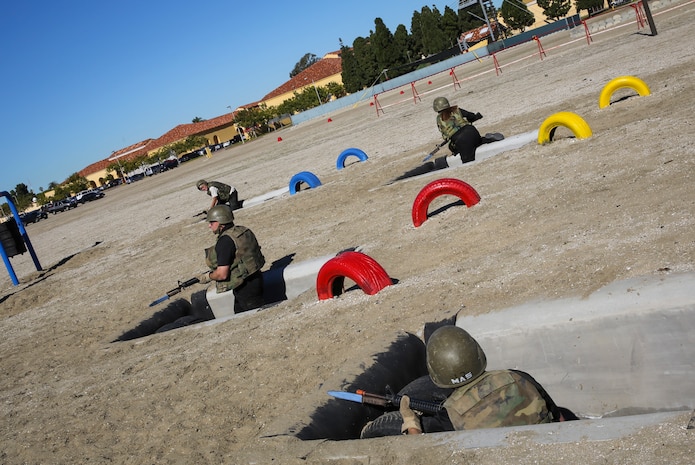 Department of Defense employees in the Executive Leadership Development Program communicate and prepare to move to the next obstacle during the Bayonet Assault Course at Marine Corps Recruit Depot San Diego, Jan. 6.  Each group had to employ efficient communication skills to maneuver and successfully accomplish the course.
