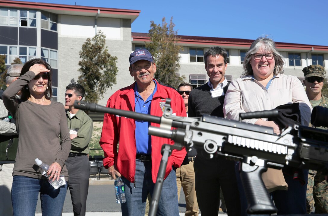 Members of the California state legislators' staff view the M249 squad automatic rifle during a tour of Camp Pendleton, Jan. 23.  The staff also viewed other weapons such as the M16 service rifle, M203 grenade launcher and M27 infantry automatic rifle. 