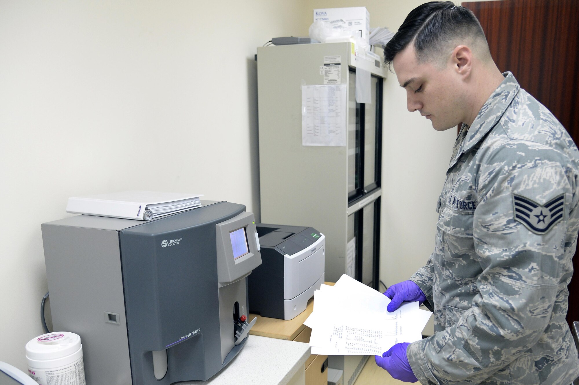 Staff Sgt. John, laboratory medical technician, looks over the parameters from a complete blood count sample analyzed with the Coulter AcT diff2 CBC machine at an undisclosed location in Southwest Asia Jan. 21, 2015. After an eight month wait, the $24K machine represents a major increase in capability for the Expeditionary Medical Group. John is currently deployed from Moody Air Force Base, Ga., and is a native of Christiansburg, Va. (U.S. Air Force photo/Tech. Sgt. Marie Brown)